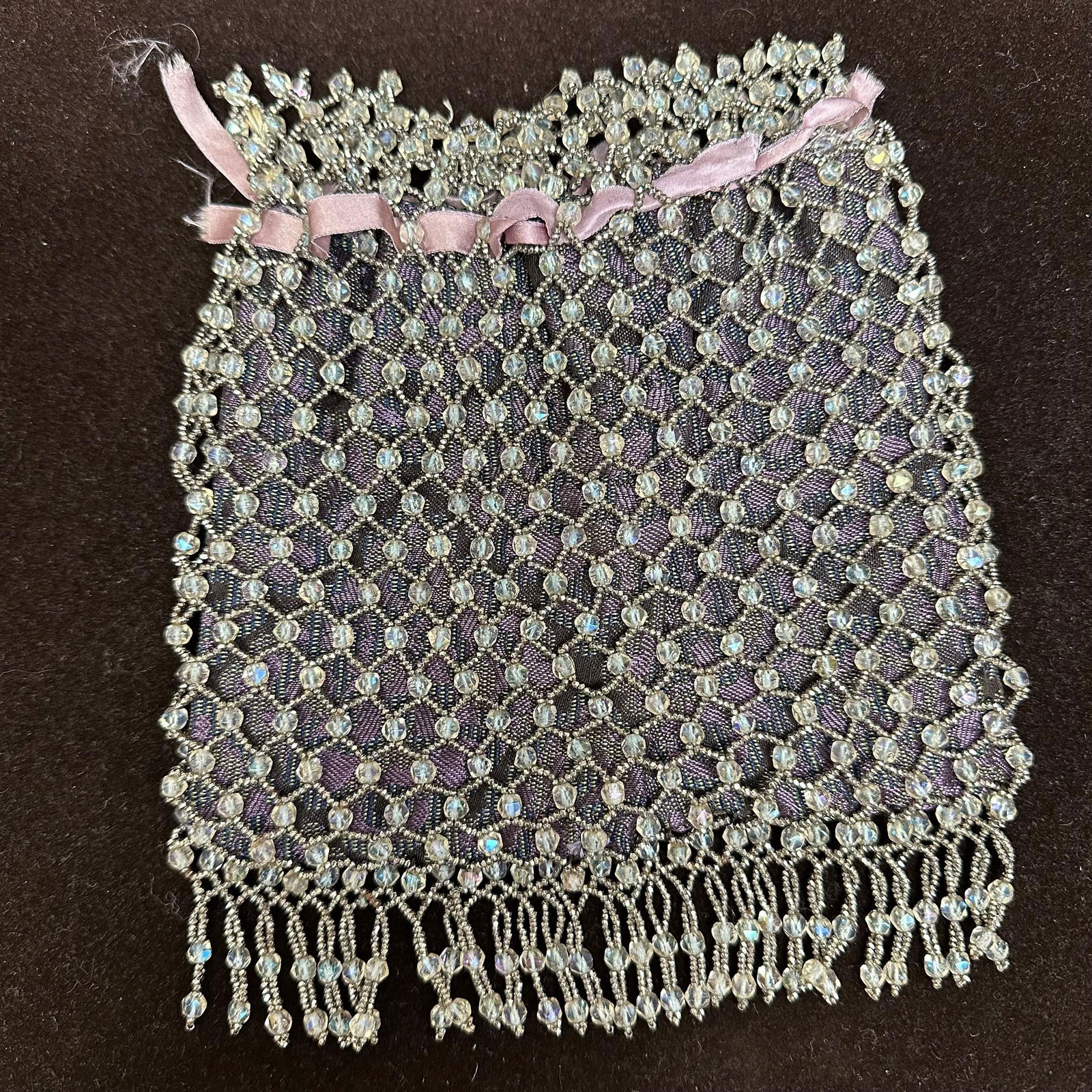 Vintage Beaded Drawstring Evening Purse with Fringe Bag: Vintage evening purse featuring a woven fabric body with an overlay of clear faceted beadwork in a net pattern. The top edge is decorated with additional beadwork and threaded with a pink ribbon draws