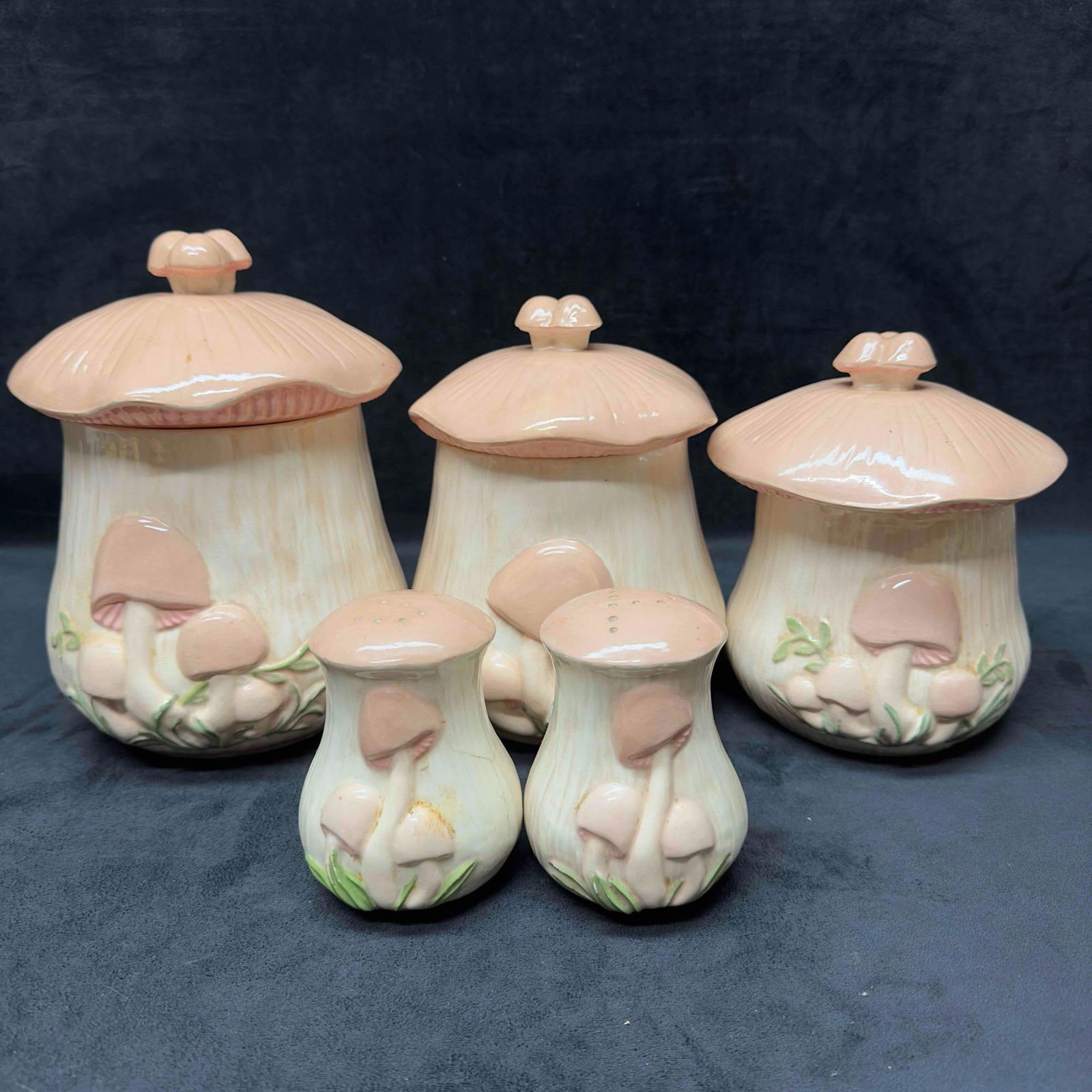 Arnels Ceramic Canisters and Salt and Pepper Shaker Pink Mushroom Design Three Canister Set: Arnels Ceramic Canisters and Salt and Pepper Shaker Mushroom Design Three Canister Set. The sale shaker and the medium canister are cracked. Light crack in the porcelain on both. The small canister