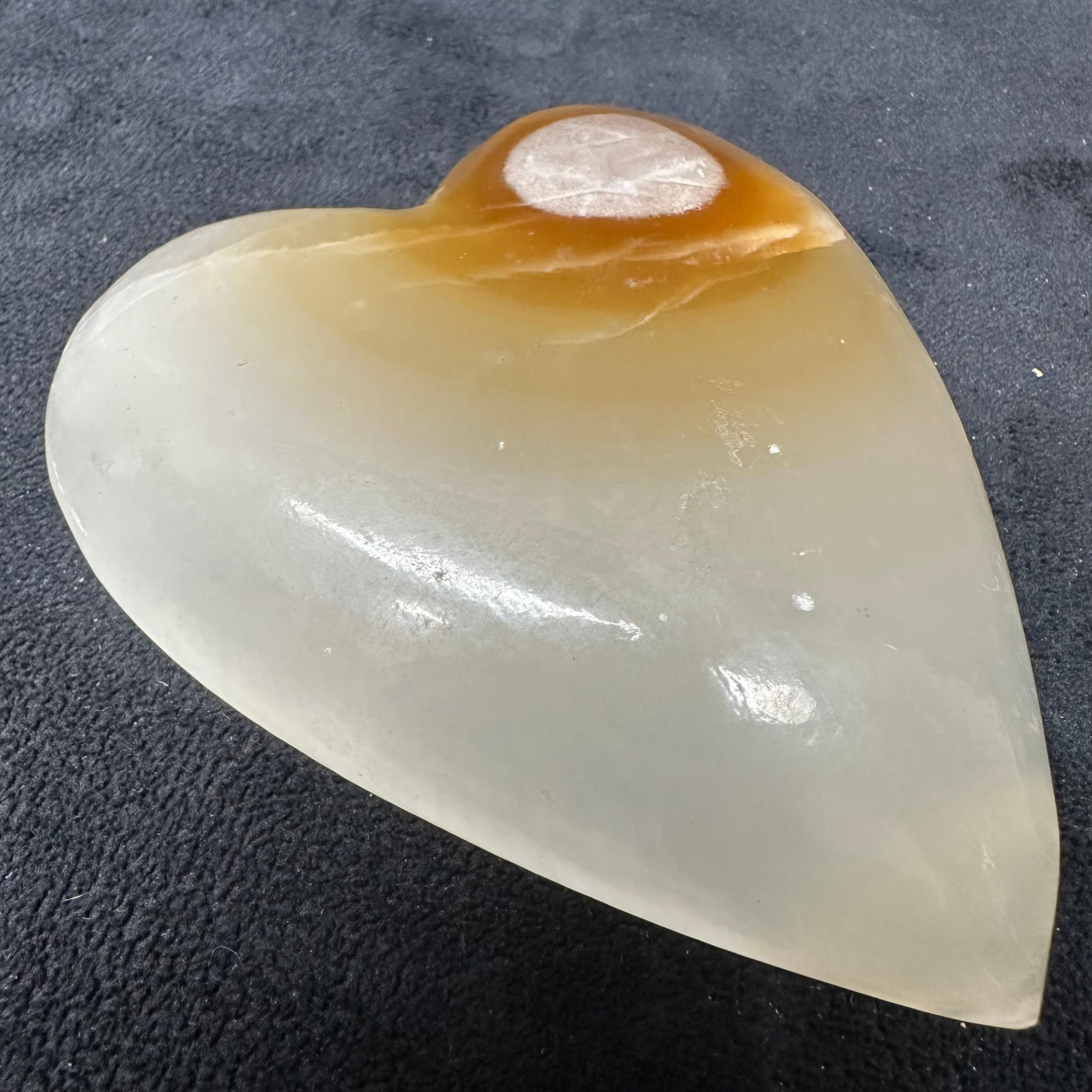 Large Polished Onyx Heart Stone Natural Brown and Cream Crystal Display Paper Weight: Beautiful, large hand-carved onyx heart featuring natural tones of cream, tan, and amber with rich translucence and organic veining. Smoothly polished with natural texture variations that enhance its