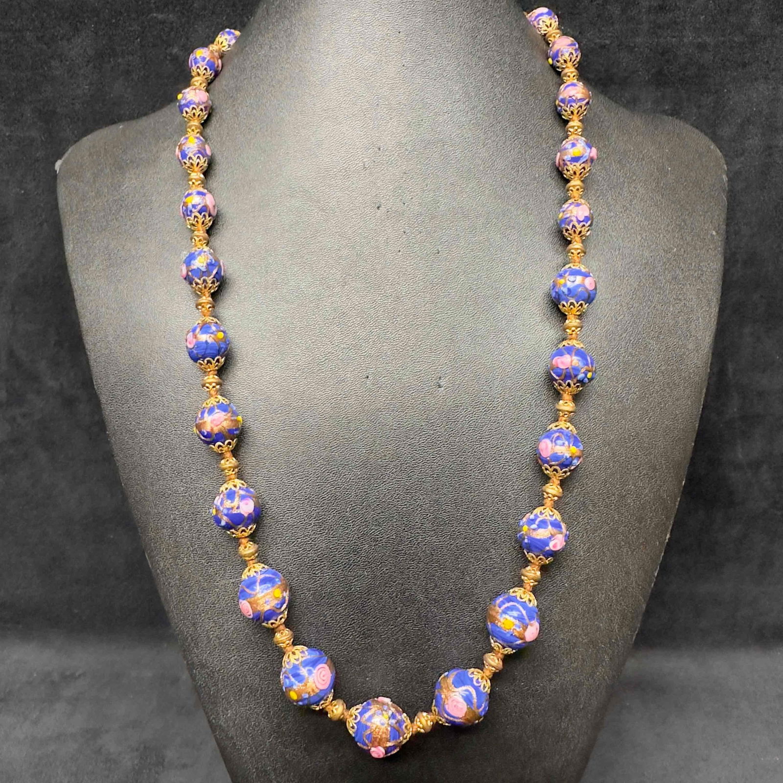 Venetian Murano Lamp Work Art Glass Dark Blue Flower Floral Copper Accent Beaded Long Necklace D47: Venetian Murano Lamp Work Art Glass Dark Blue Flower Floral Copper Accent Beaded Long Necklace D47. Necklace with blue colored glass beads with beautiful designs on each. The necklace features floral