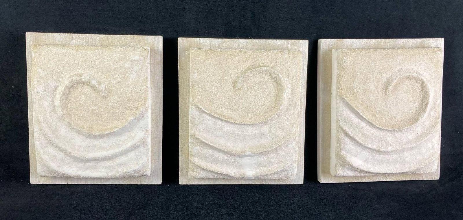 (3) Plaster and Wood Swirl House Decorations: Up for auction are three swirl wall decorations fresh from a recent estate. They are all white plaster swirl or wind designed wall mounts. The plaster are on wood boards ready for wall display. This a