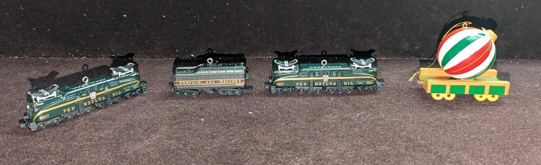 4 Hallmark & AVON Train Christmas Ornaments: 4 Hallmark & AVON Train Christmas Ornaments. This lot includes (2) Hallmark Keepsake Ornaments - Pennsylvania GG-1 Locomotive Lionel Train. This was released in 1998. Both come in the original bo