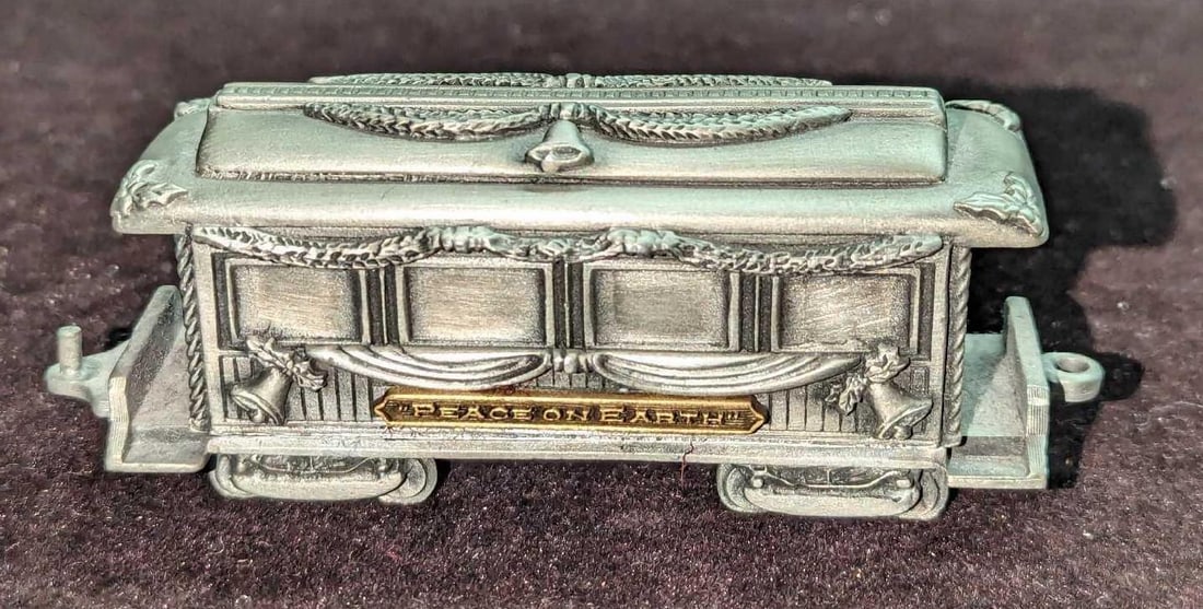 Pewter Santa's Express Peace On Earth Figurine: Pewter Santa's Express Peace On Earth Figurine. This is approx 4" x 1 1/4" x 1 3/4 and it weighs 0.50lb. This was released in 1994. The figurine has light wear.