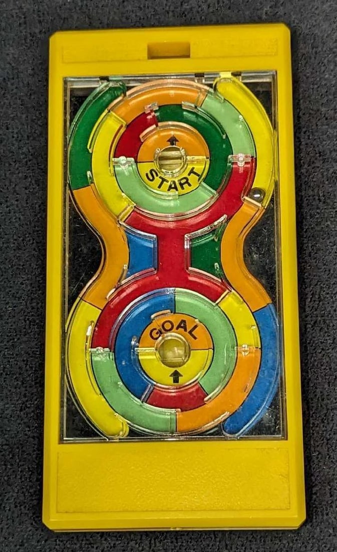 Vintage Epoch Co Ball Maze Handheld Game Of Skill: Vintage Epoch Co Ball Maze Handheld Game Of Skill. This was released in the year 1976. This is approximately 5 3/8" x 2 5/8" x 5/8" and it weighs 0.14lb. The clear plastic 'screen' has some markings.
