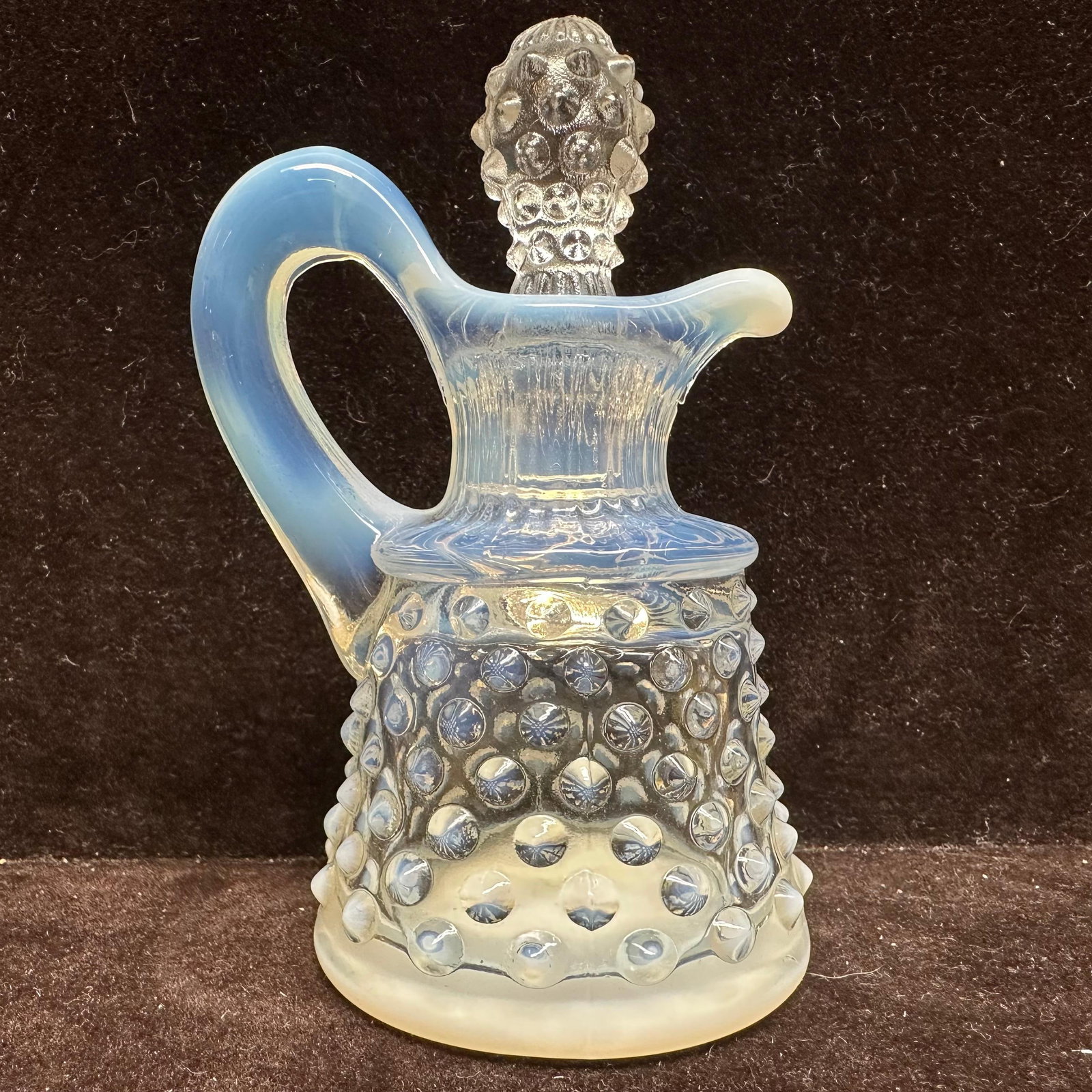 Fenton Art Glass Oil Cruet Hobnail Blue Moonstone Opalescent with Stopper: This is a vintage Fenton Art Glass oil cruet in the Hobnail pattern, featuring a distinctive white or blue moonstone opalescent finish and its original stopper. This item is in good pre-owned, previou