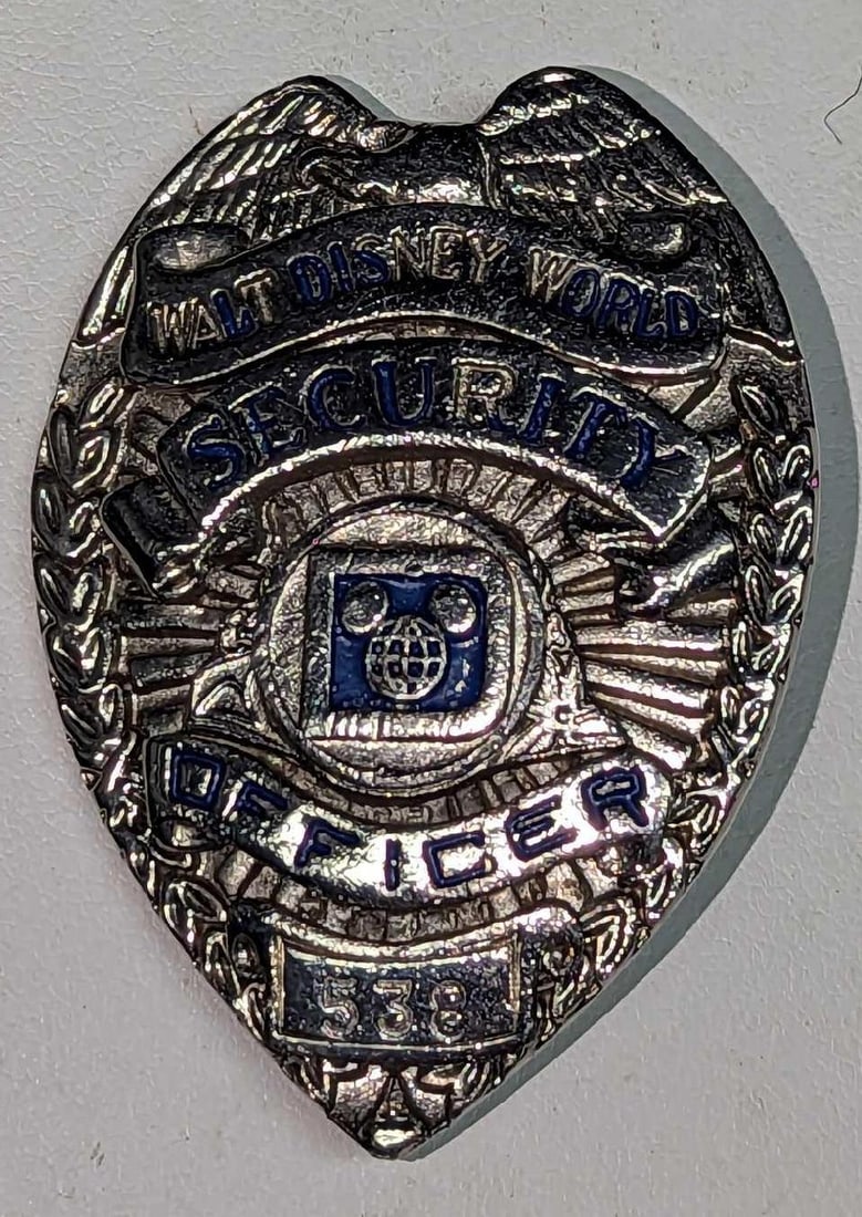Early 1980s Disney World Female Security Badge 538: Early 1980s Disney World Female Security Badge 538. Is approx 1 5/8" x 1/4" x 2 3/4" and it weighs under one pound at 0.08lb. The metal badge is in a good, vintage condition with some scratches a