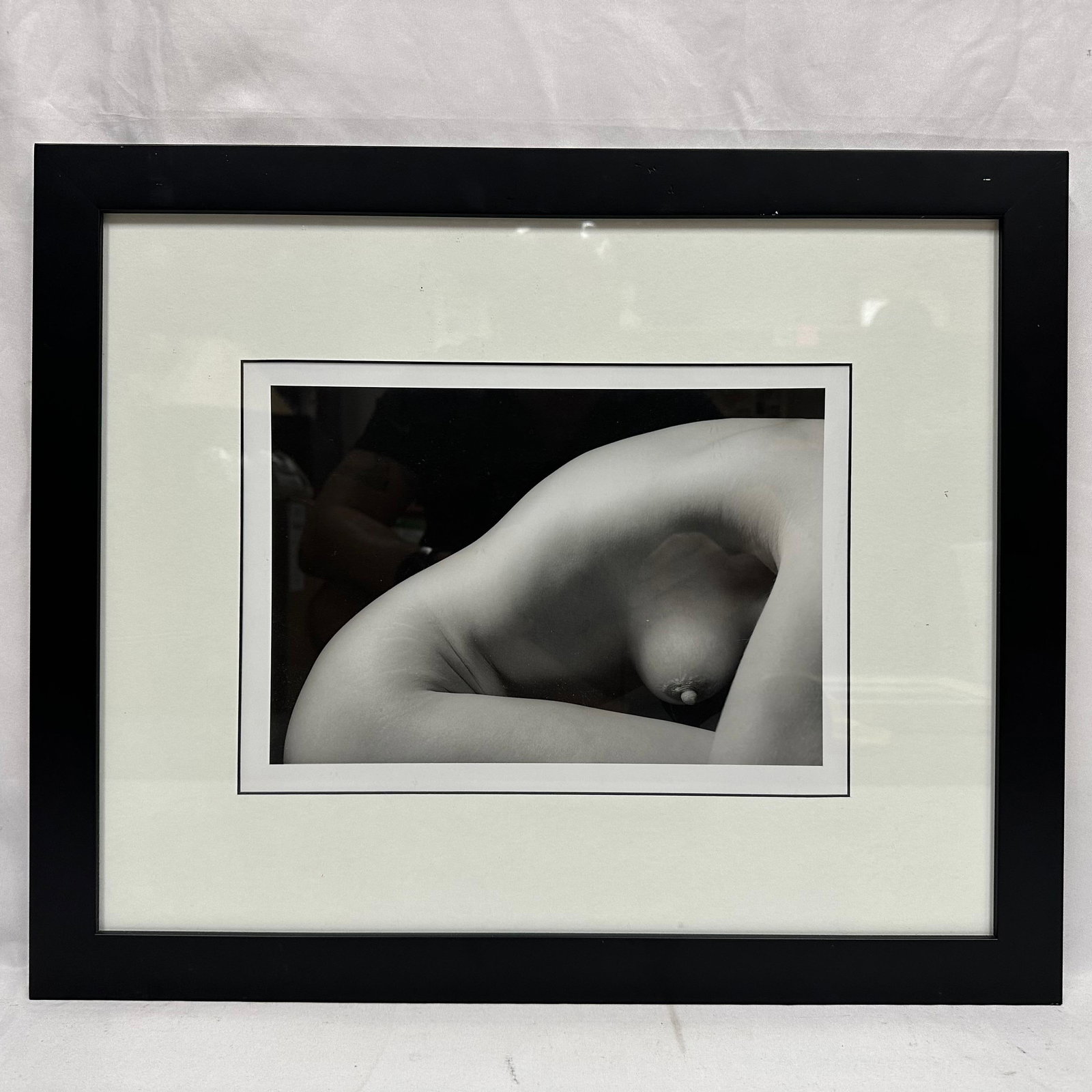 Black and White Artistic Nude Female Figure Framed and Matted: Black-and-white fine art photograph depicting an abstracted pose of a nude female figure. The composition focuses on curvature, form, and shadow, presented tastefully and artistically. The print is pr