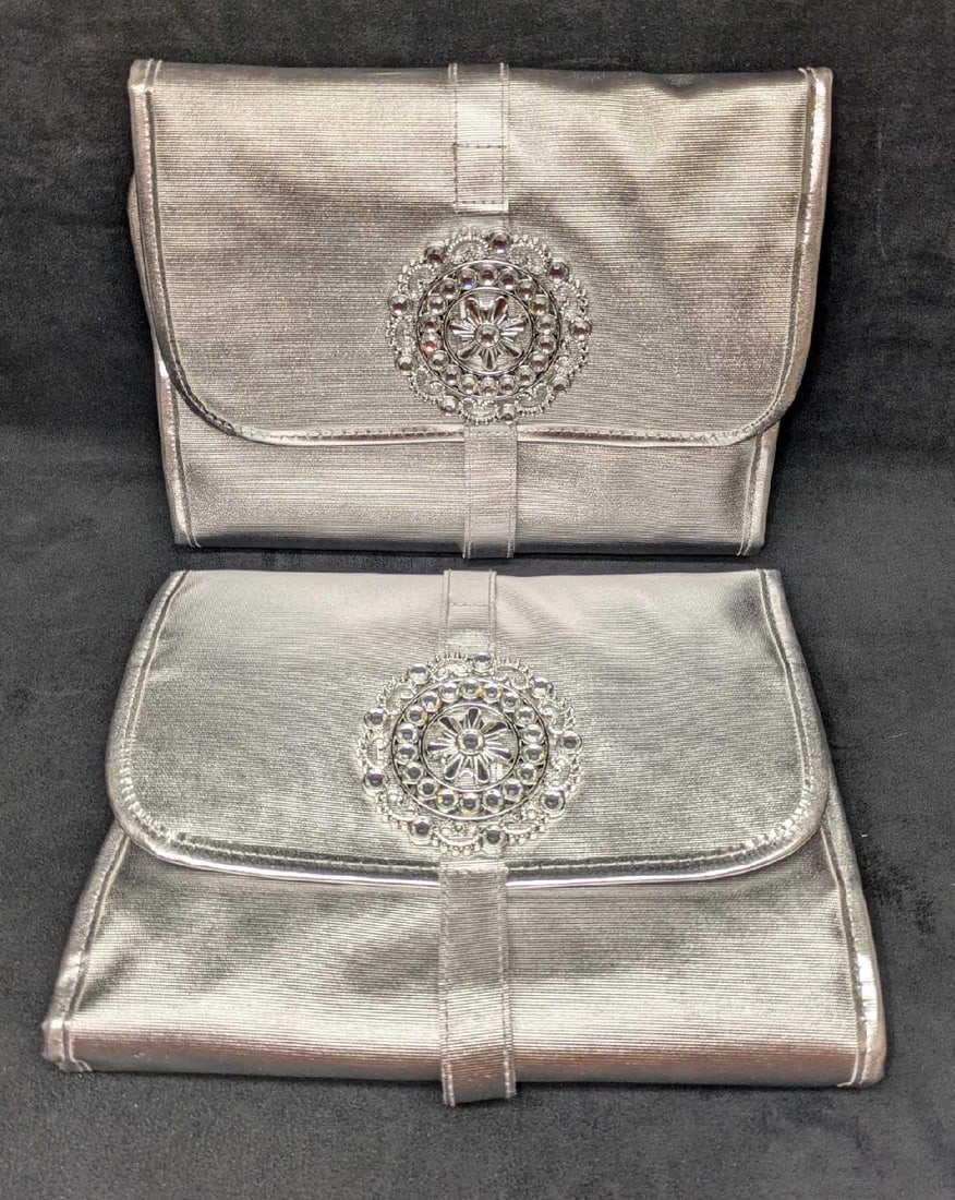 2 Travel Cosmetic And Jewelry Organizer Bag: 2 Travel Cosmetic And Jewelry Organizer Bag. Each is approx 11" x 9 1/2" x1 1/2" and the total weight is 1lb. Has an silver tone front decoration with rhinestones. Has 11 zipper pockets and one large