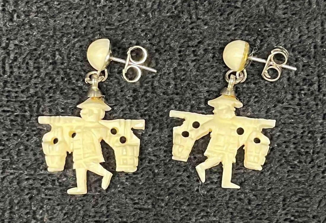 Hand Carved Bone Man With Shoulder Yoke Dangle Earrings: This lot contains Hand Carved Bone Man With Shoulder Yoke Dangle Earrings. Each earring is approx 1 1/4" x 3/4" x 1/4". Total weight is less than 1 gram. Overall the Hand Carved Bone Earrings are in