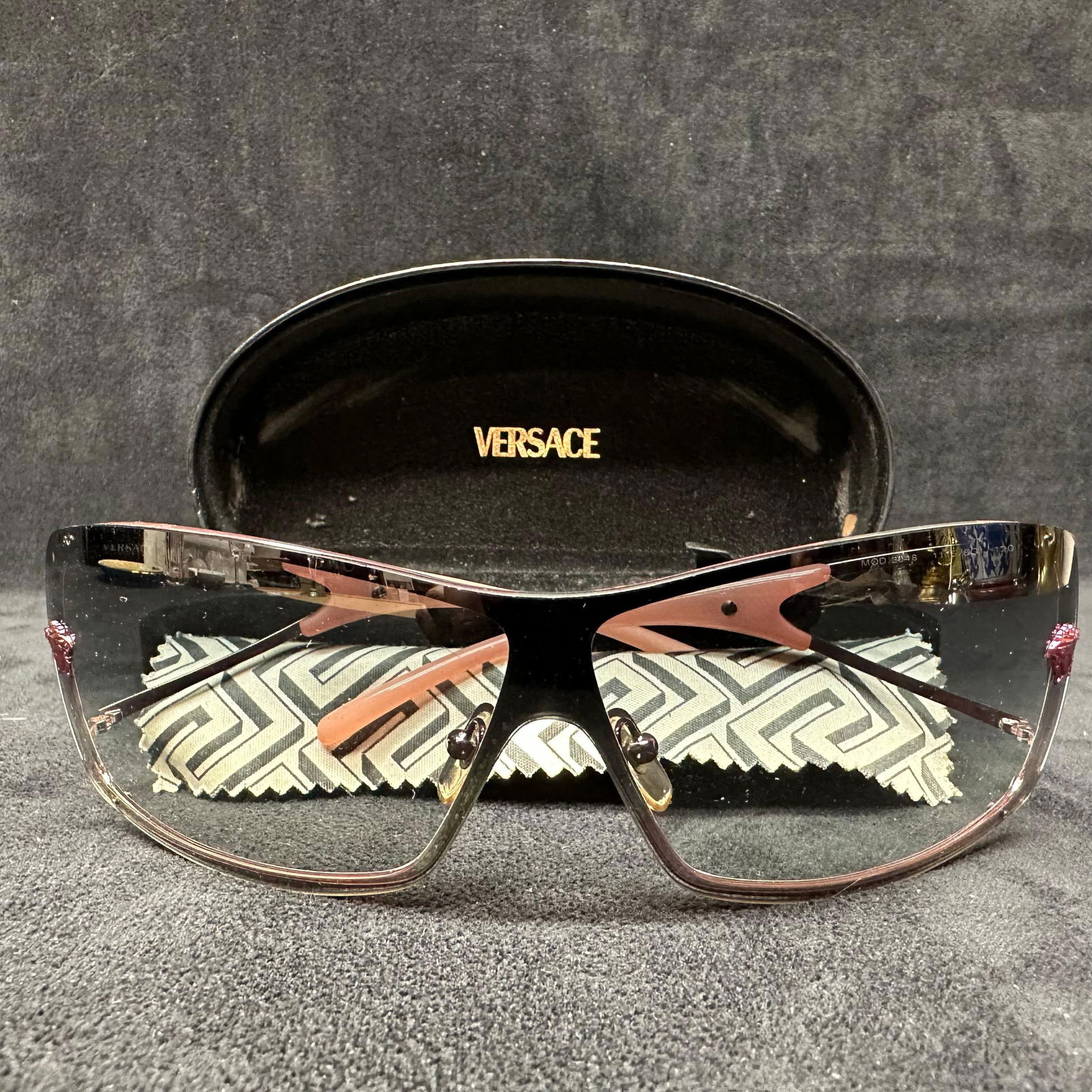 Versace Designer Sunglasses Model 2048 Rose Gold Tone Frame with Tinted Lenses Case: Versace designer sunglasses, model 2048, featuring a rose gold-tone metal frame with tinted lenses and sculptural temples. Marked Versace Made in Italy. Includes original Versace hard case and