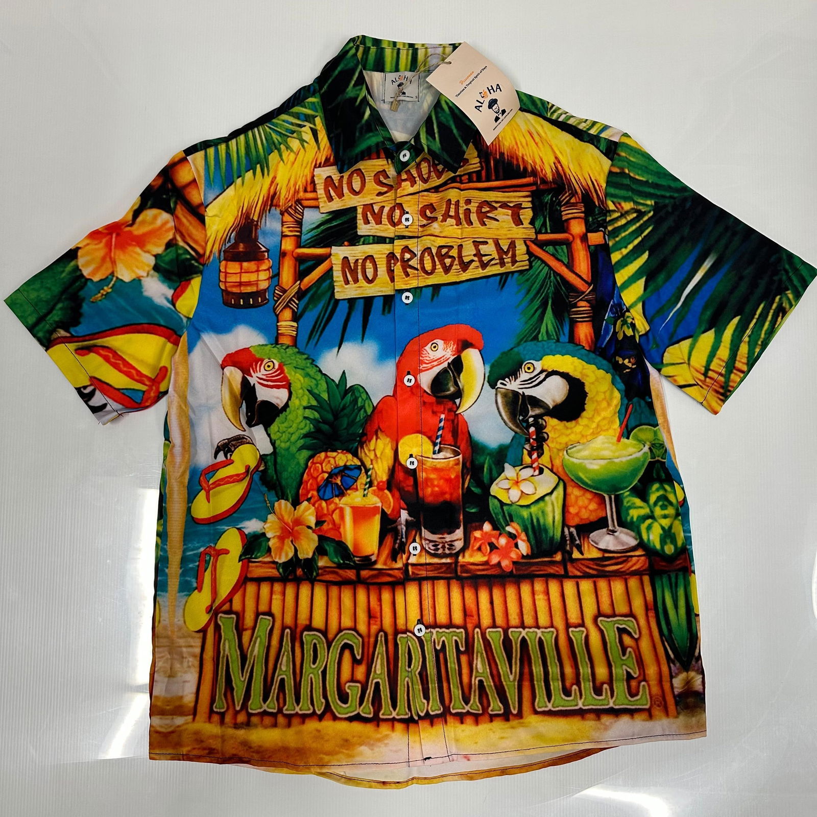 Aloha Margaritaville Tropical Parrot Button Up Shirt Small: Short-sleeve tropical button-up shirt by Aloha featuring a colorful Margaritaville theme with parrots and island graphics. Marked size Small. New with original hang tags attached. Fabric tag reads