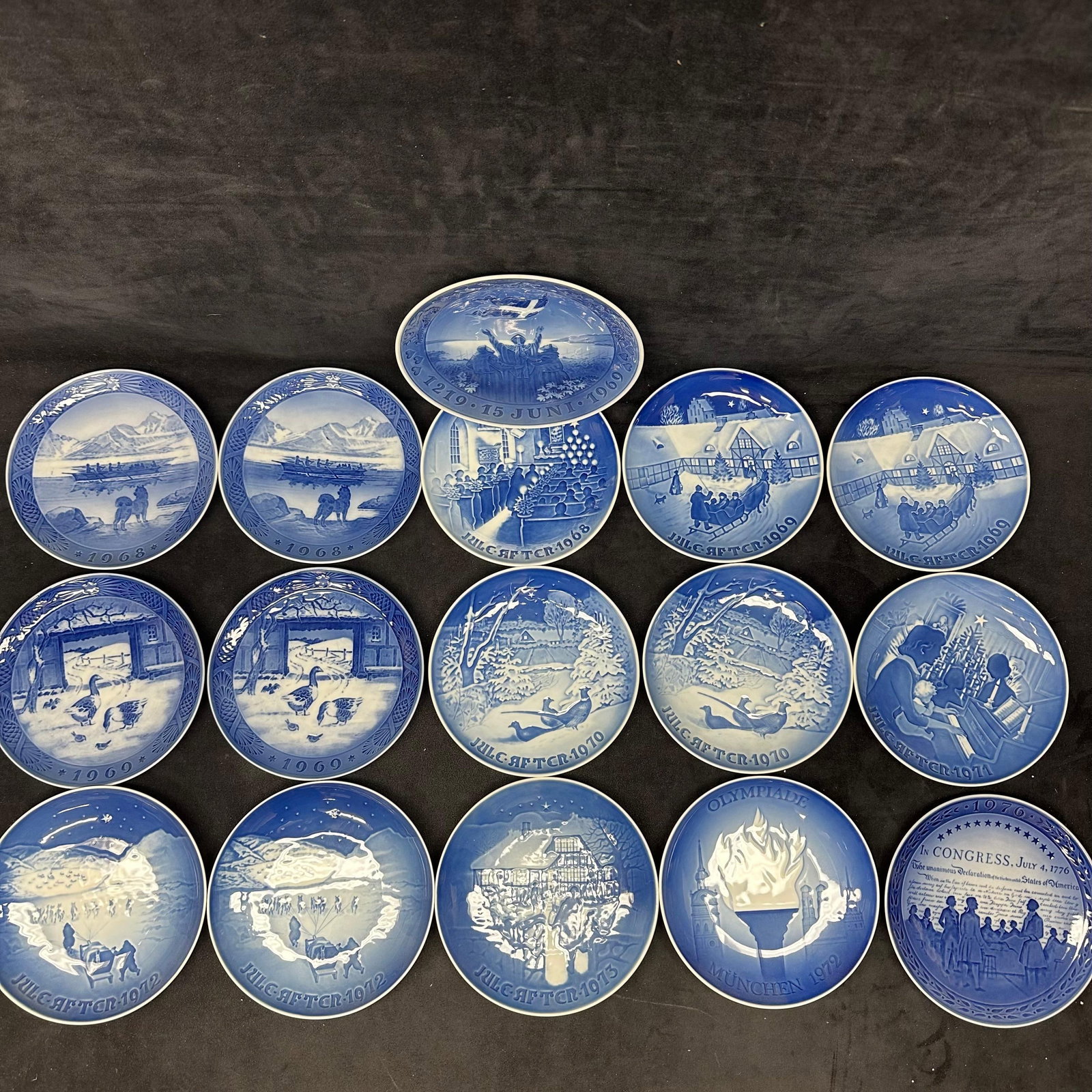 Sixteen Large Lot of Blue and White Royal Copenhagen Bing and Grondahl Plate Collectibles: Collection of 16 blue and white porcelain collector plates, including Royal Copenhagen and Bing & Grondahl Christmas plates, Olympic plate, and commemorative plates. Various years. All with
