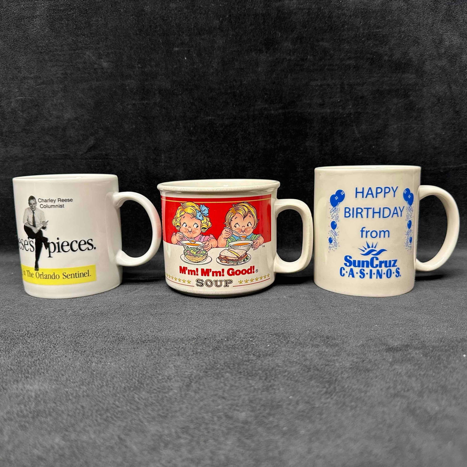 Coffee Mug Lot Charley Reese Orlando Sentinel 1989 Campbell’s Soup Kids SunCruz Casinos: Lot of three vintage ceramic mugs. Includes a Charley Reese Orlando Sentinel promotional mug by Industrial Co., Winter Park, Florida; a 1989 Campbell’s Soup Company “M’m! M’m! Good!” mug