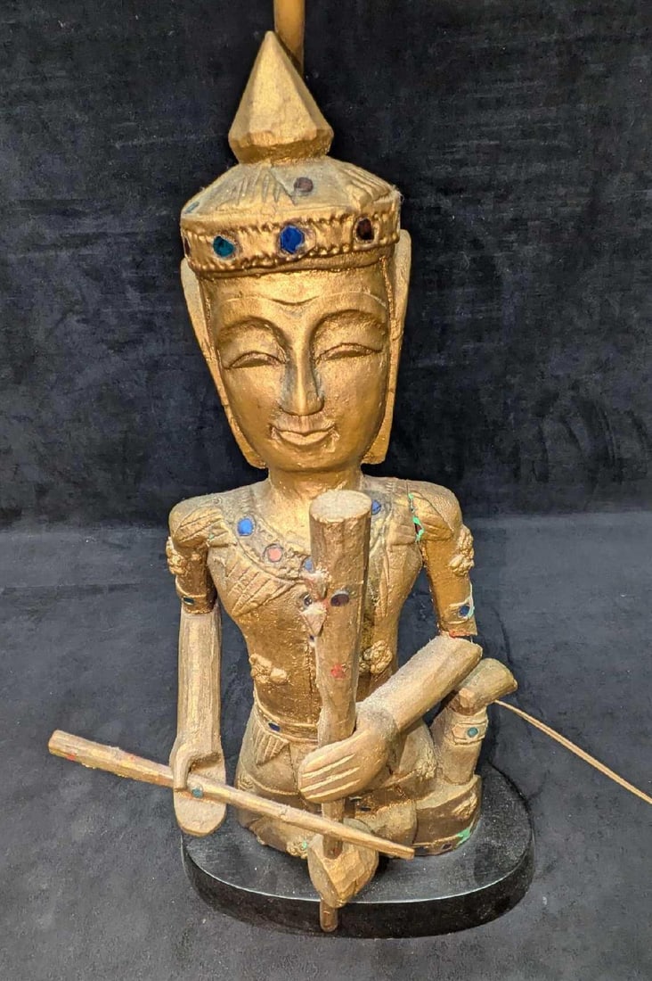 Vintage Thai Or Burmese Carved Gilt Wood Converted Lamp: Vintage Thai Or Burmese Carved Gilt Wood Converted Lamp. Untested. This is 11" x 6 1/2" x 31 1/2" (the harp cannot be removed) and it weighs 2.80lbs. There are cracks on the arms. Please see the image