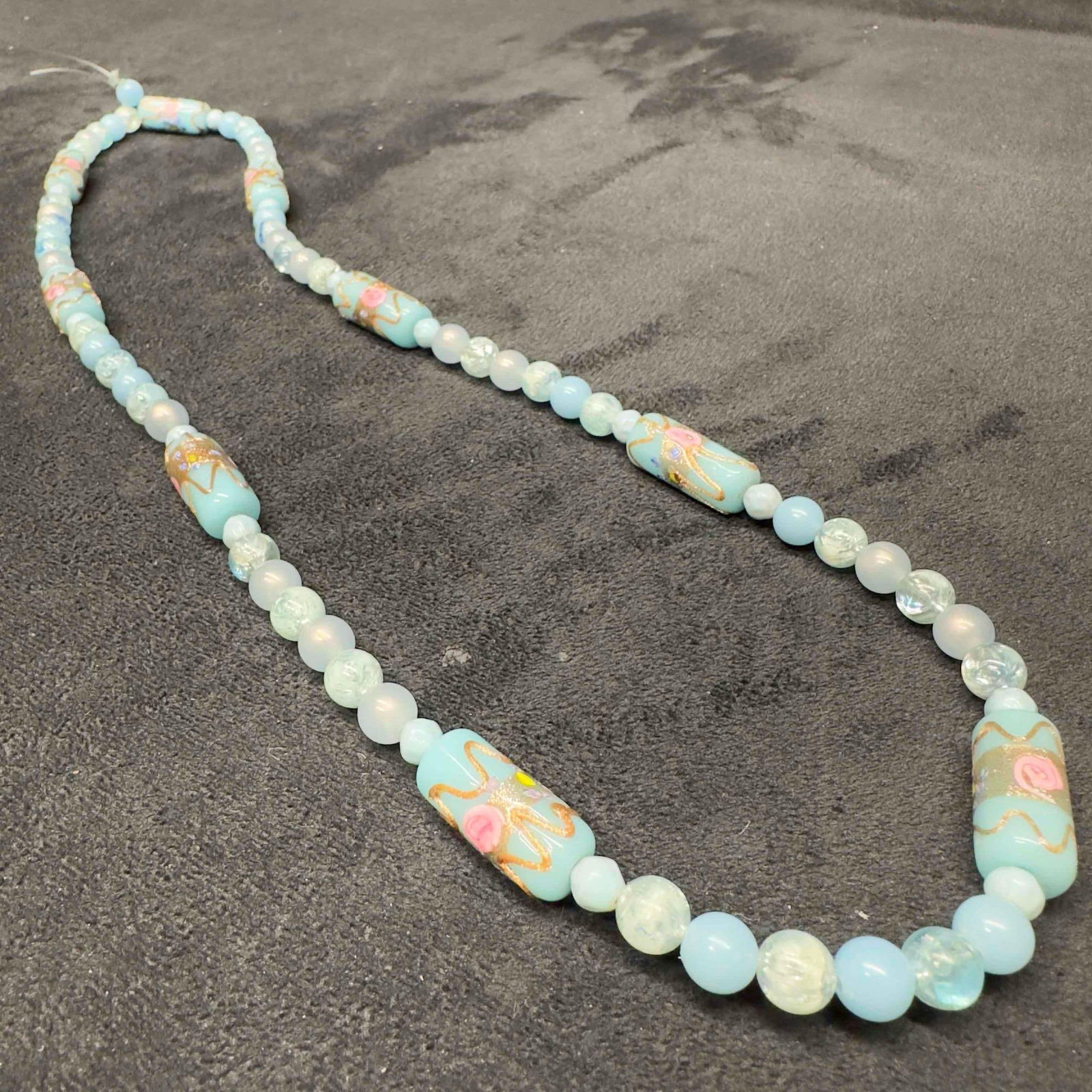 Murano Venetian Lamp Work Art Glass Light Blue Bead Floral Copper Accent Beaded Necklace F51: Murano Venetian Lamp Work Art Glass Light Blue Bead Floral Copper Accent Beaded Necklace F51. Necklace with light blue colored glass beads with a beautiful design on each. The necklace features pink f