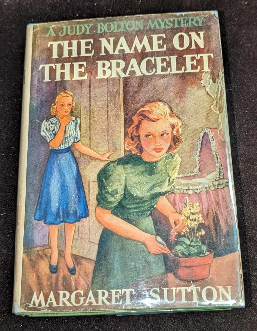 1st Ed Judy Bolton The Name On The Bracelet HC #13: 1st Ed Judy Bolton The Name On The Bracelet HC #13. "A Judy Bolton Mystery - The Name On The Bracelet ". By Margaret Sutton (The pen name of Rachel Beebe) and was published by Grosset & Dunlap (New Yo