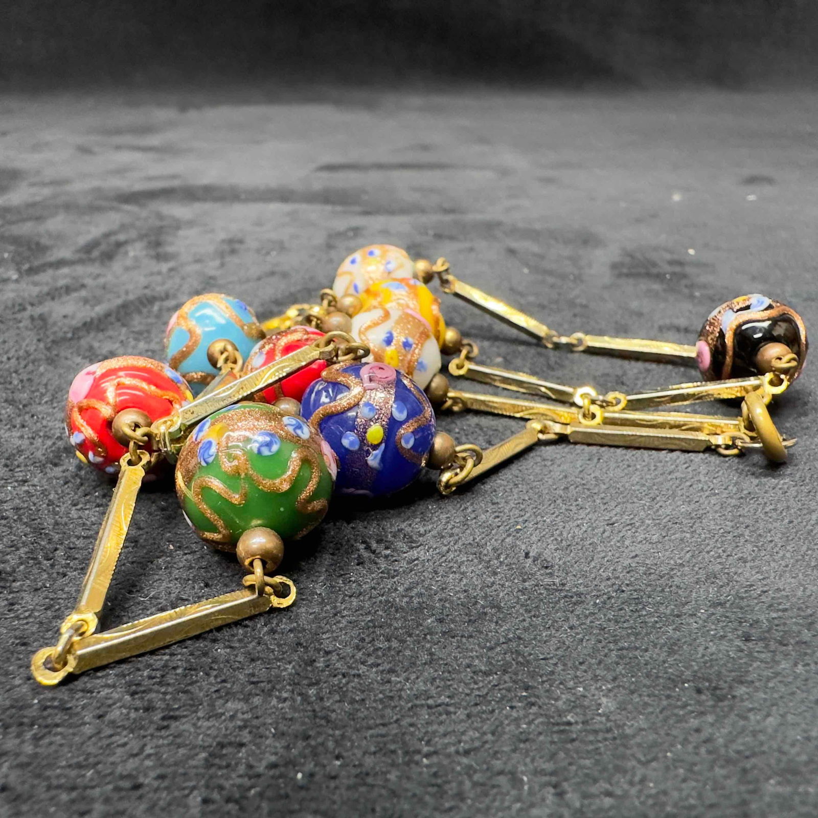 Murano Venetian Lamp Work Glass Multi Colored Round Bead Gold Toned Necklace B4: Murano Venetian Lamp Work Glass Multi Colored Round Bead Gold Toned Necklace B4. Necklace with multi colored glass beads with beautiful hand painted floral designs on each. The necklace features coppe