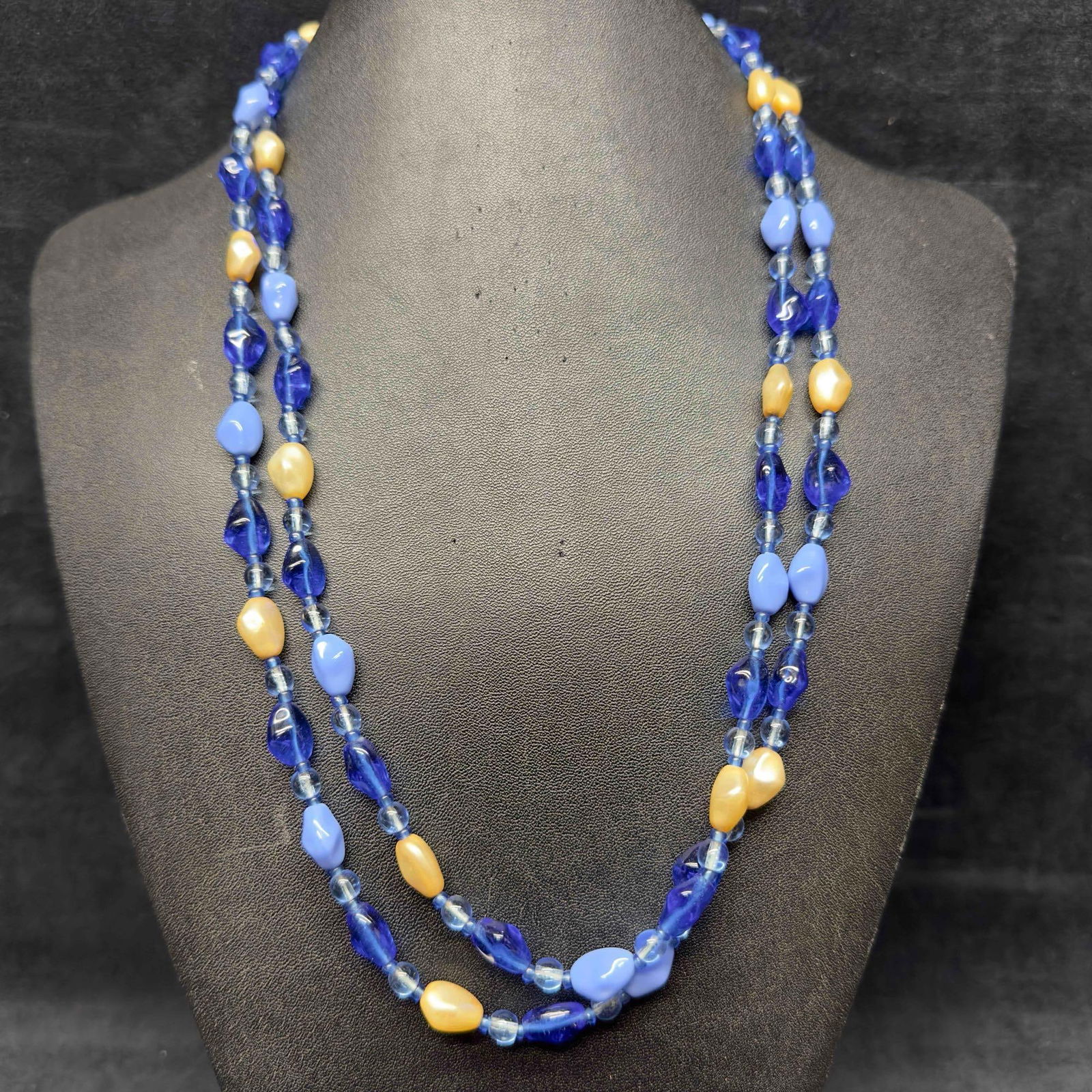 Venetian Murano Lamp Work Glass Art Various Blue Colors Beaded Long Necklace E65: Venetian Murano Lamp Work Glass Art Various Blue Colors Beaded Long Necklace E65. Necklace with various shades of blue colored glass beads with a beautiful design on each. The necklace features pearl