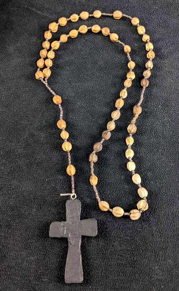 Handmade Rosary: Handmade Rosary This rosary looks to be handmade with small beads, dried-up nuts, and a wooden cross. This rosary is very unique and beautiful. This item is in good vintage condition with No known dam