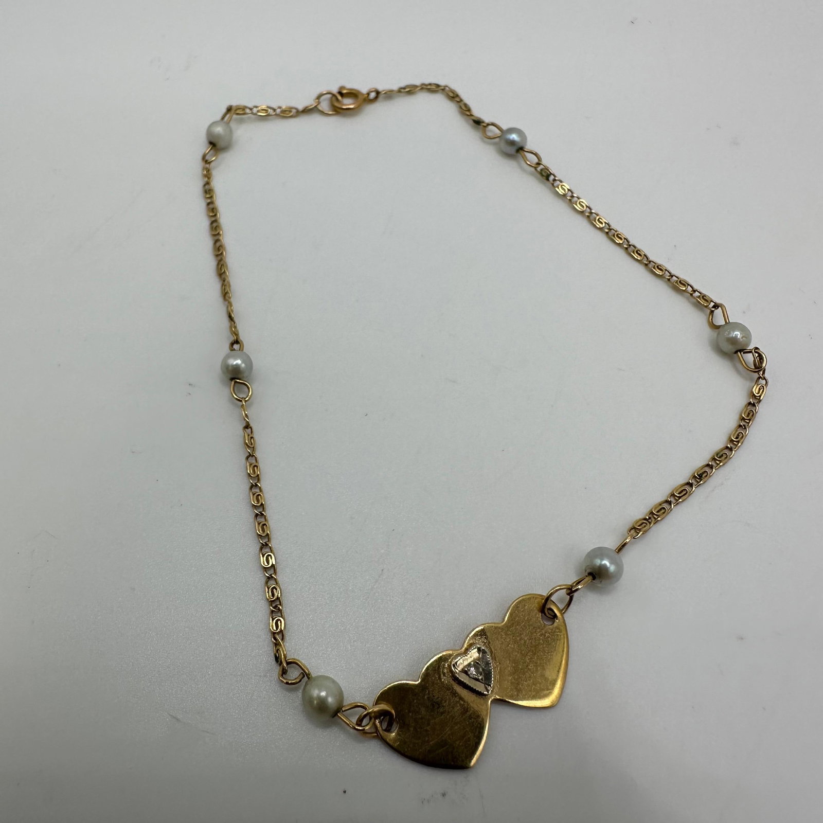 14K Yellow Gold Accent Diamond Double Heart Cultured Pearl Bracelet: This item is in good pre-owned, previously used/displayed condition with noticeable light wear and surface scratches. Please reference all photos for full details. This piece of jewelry has been teste