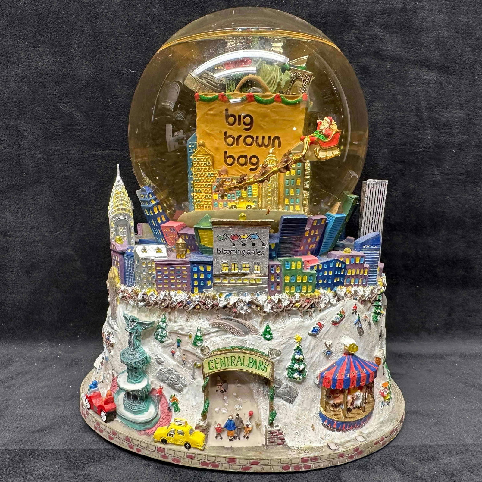 Bloomingdales Big Brown Bag NYC Central Park Twin Towers Music Light Up Snow Globe: Fully functional, turn key music and lights working. A few lights and pieces broken of the water globe. This item is in good pre-owned, previously displayed condition with light wear, a few broken