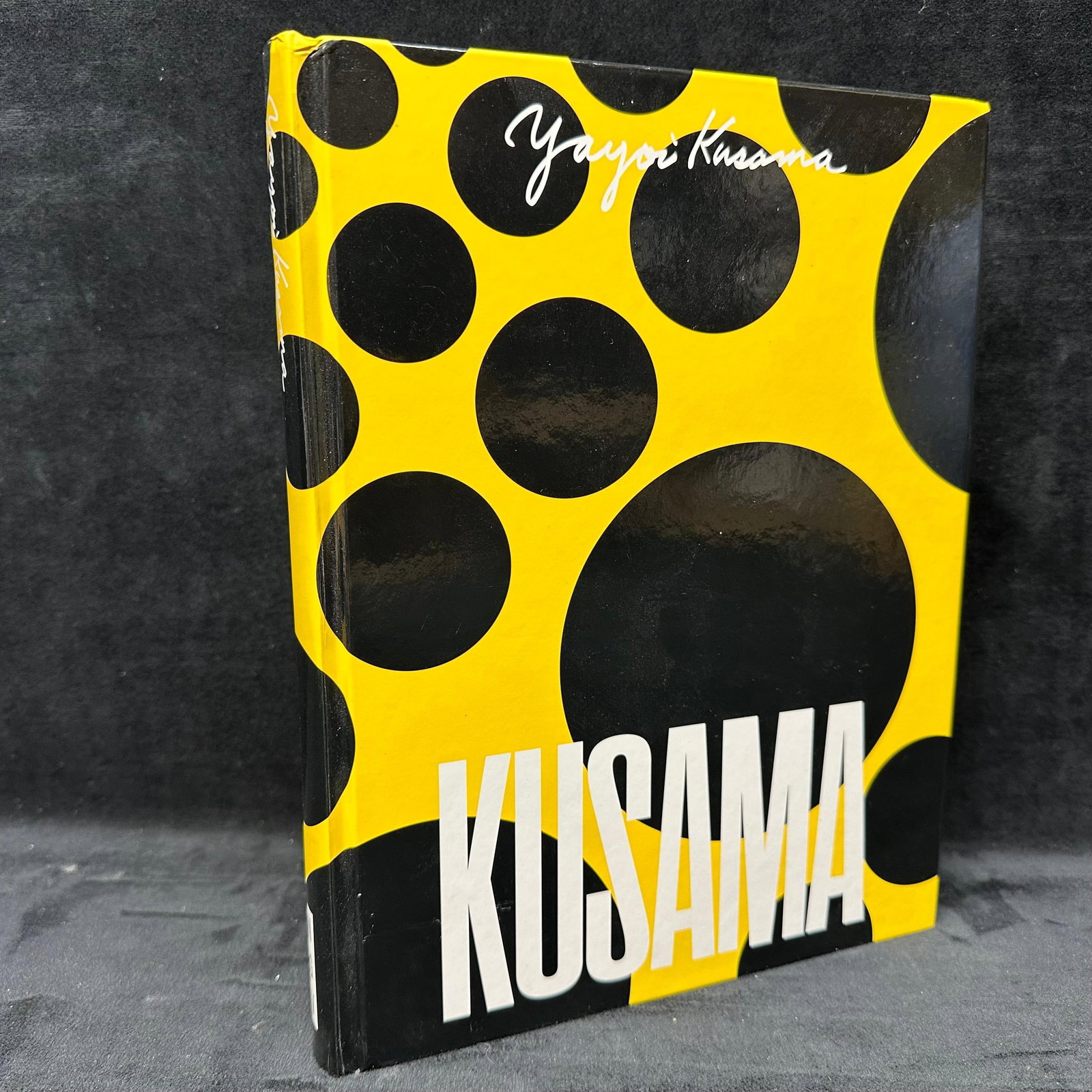 Yayoi Kusama NGV Exhibition Hardcover Book Signed by Contributors Black and Yellow Polka Dots #2: Four signatures from the contributors are on the inside title page. Signatures by Wayne Crothers, Miranda Wallace, Meg Slater, and Coral Guan. Book cover and pages are in good condition, and appear to