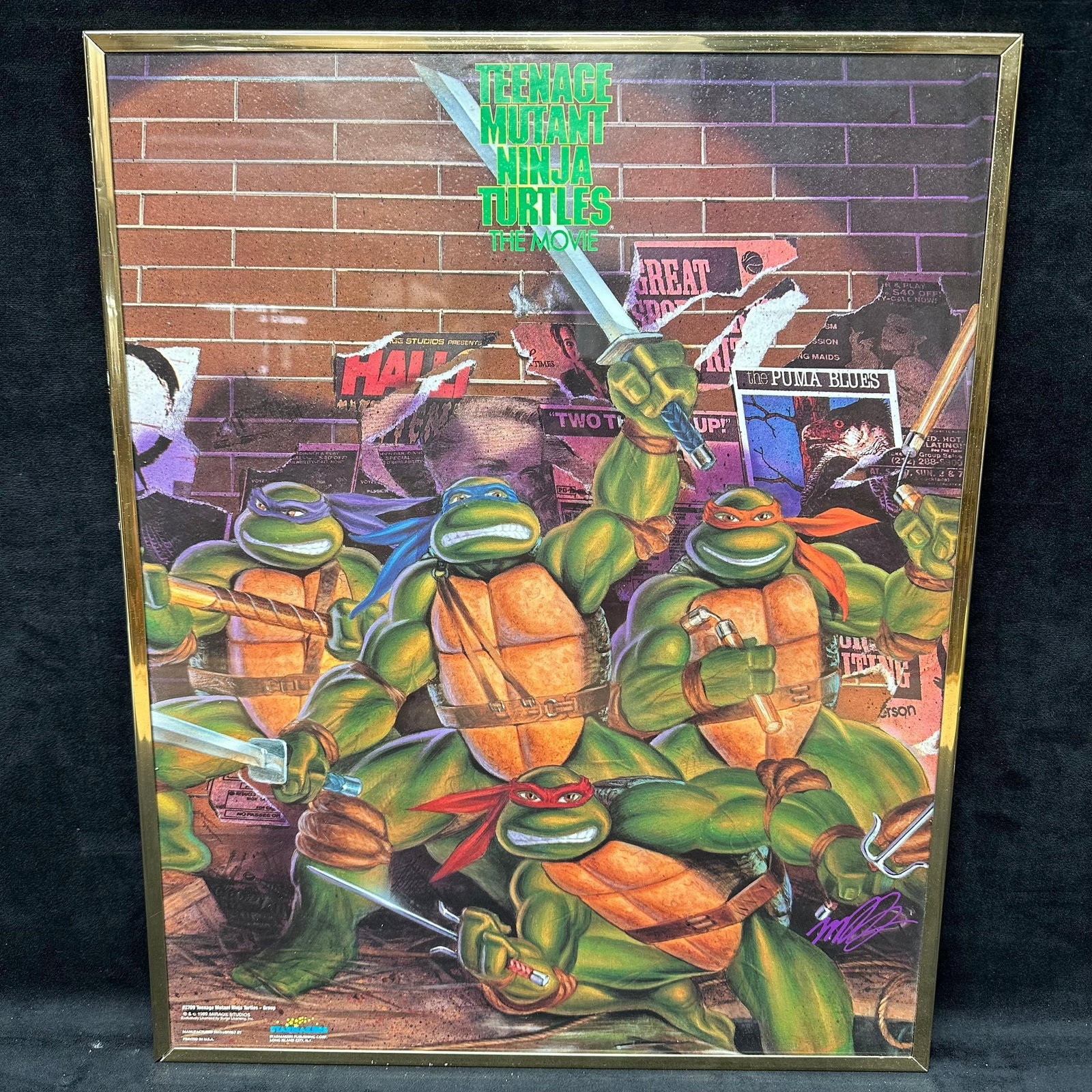 Teenage Mutant Ninja Turtles The Movie Framed Poster Mirage Studios: Framed Teenage Mutant Ninja Turtles: The Movie poster featuring the four turtles in front of a brick wall collage background. Marked lower left #2709 Teenage Mutant Ninja Turtles Group and 1989 Mirage