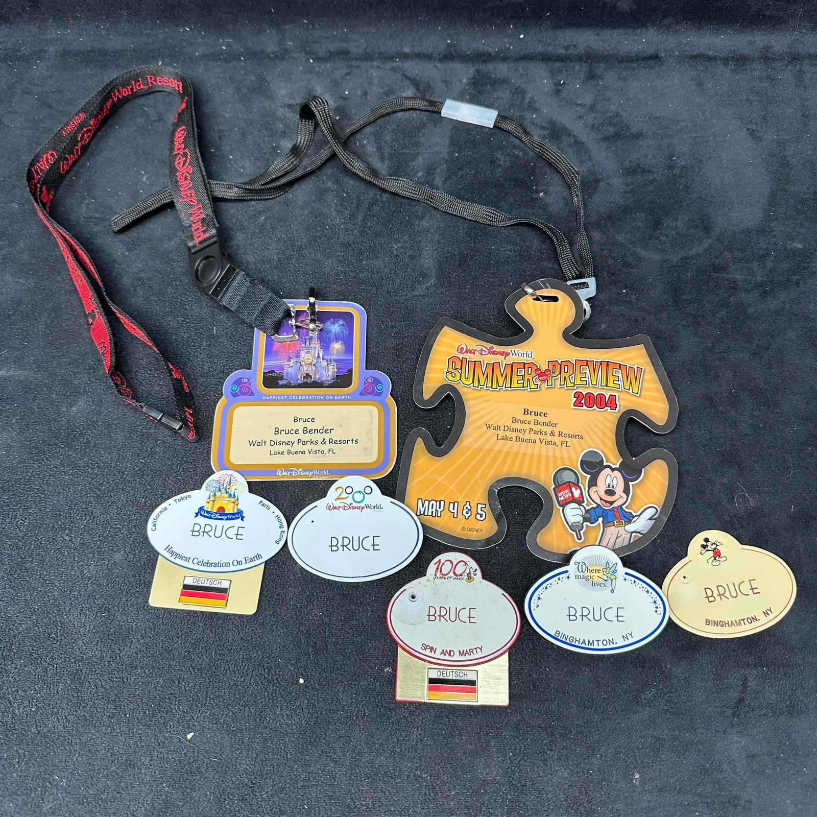Lot of Disney Cast Member Name Tags and Event Lanyards Bruce Collection: Collection of authentic Walt Disney World Cast Member memorabilia belonging to “Bruce.” Includes five Disney name tags (various designs including 2000 Millennium Celebration, 100 Years of Magi