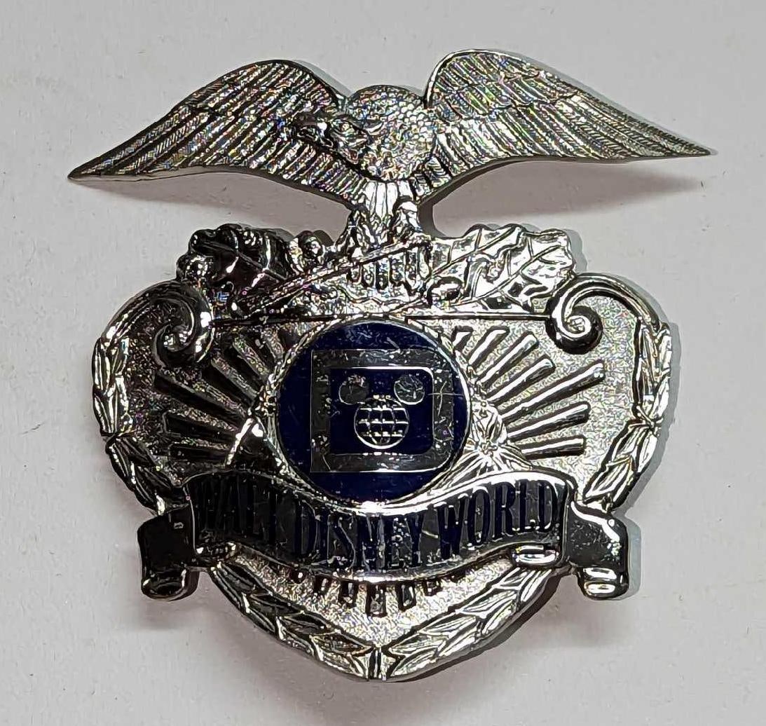 Early 1980s Disney World Security Badge: Early 1980s Disney World Security Badge. This is approx 2 1/2" x 1/4" x 2 1/2" and it weighs 0.10lb. Please note, the number normally visibile on the back was covered up by a new pinback.