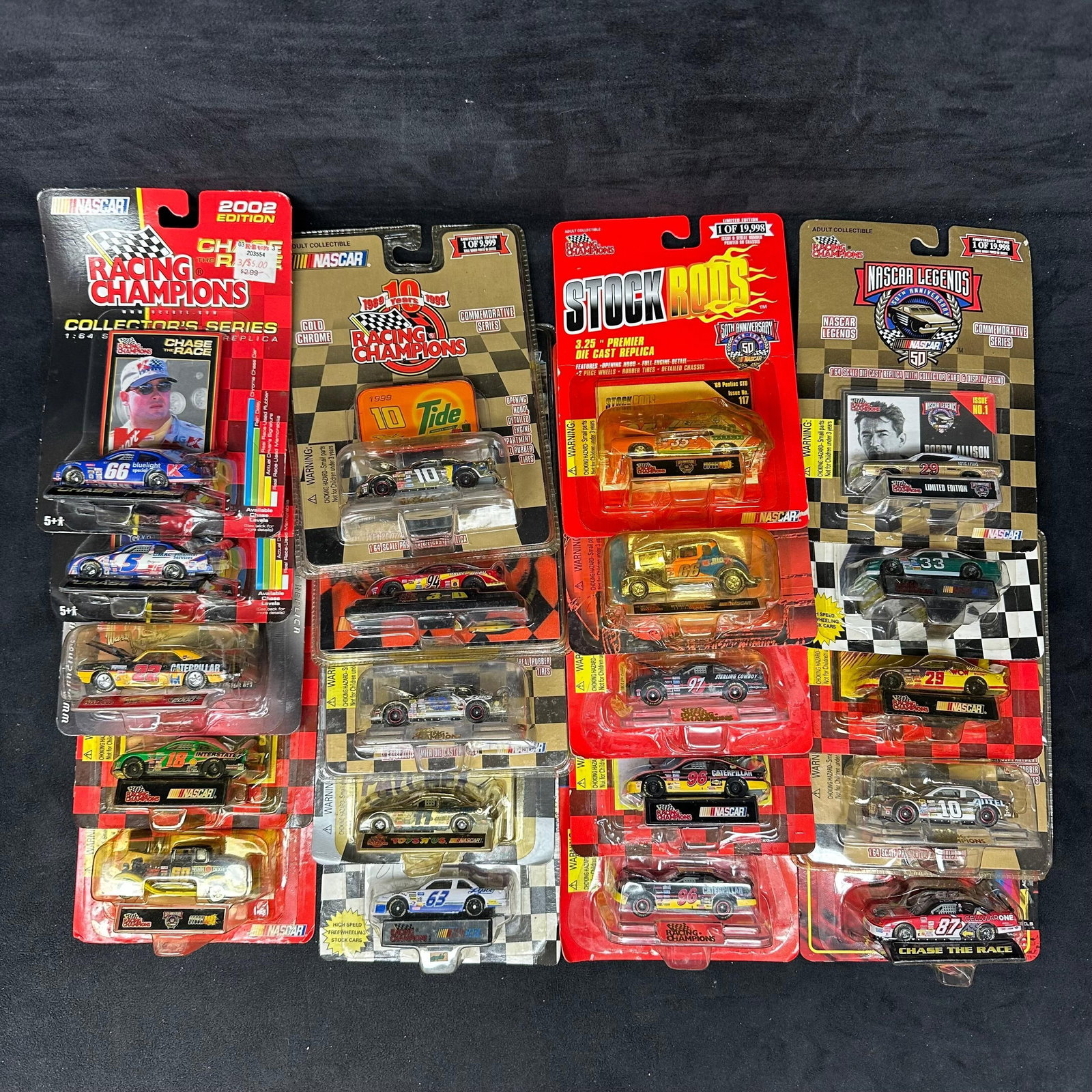 20 NASCAR Racing Champions and Stock Rods Diecast Cars: Group of 20 NASCAR diecast cars, including Racing Champions, Stock Rods, and NASCAR Legends series examples. Various drivers and sponsors represented. Cars remain sealed in original packaging with lig