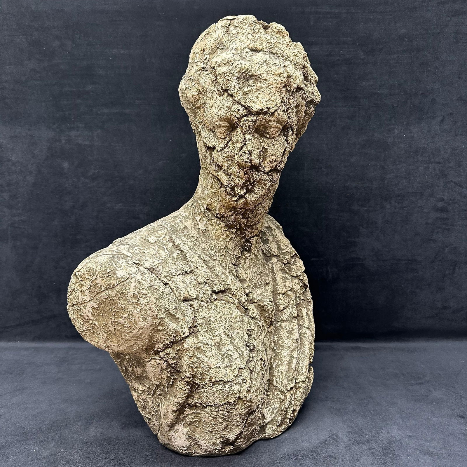 Antique Style Plaster Textured Stone Like Composite Female Bust Sculpture: Classical style female bust sculpture featuring a highly textured, cracked, and weathered stone-like finish. Crafted in a light plaster-textured concrete-style sculpture, themed in a Greco-Roman desig