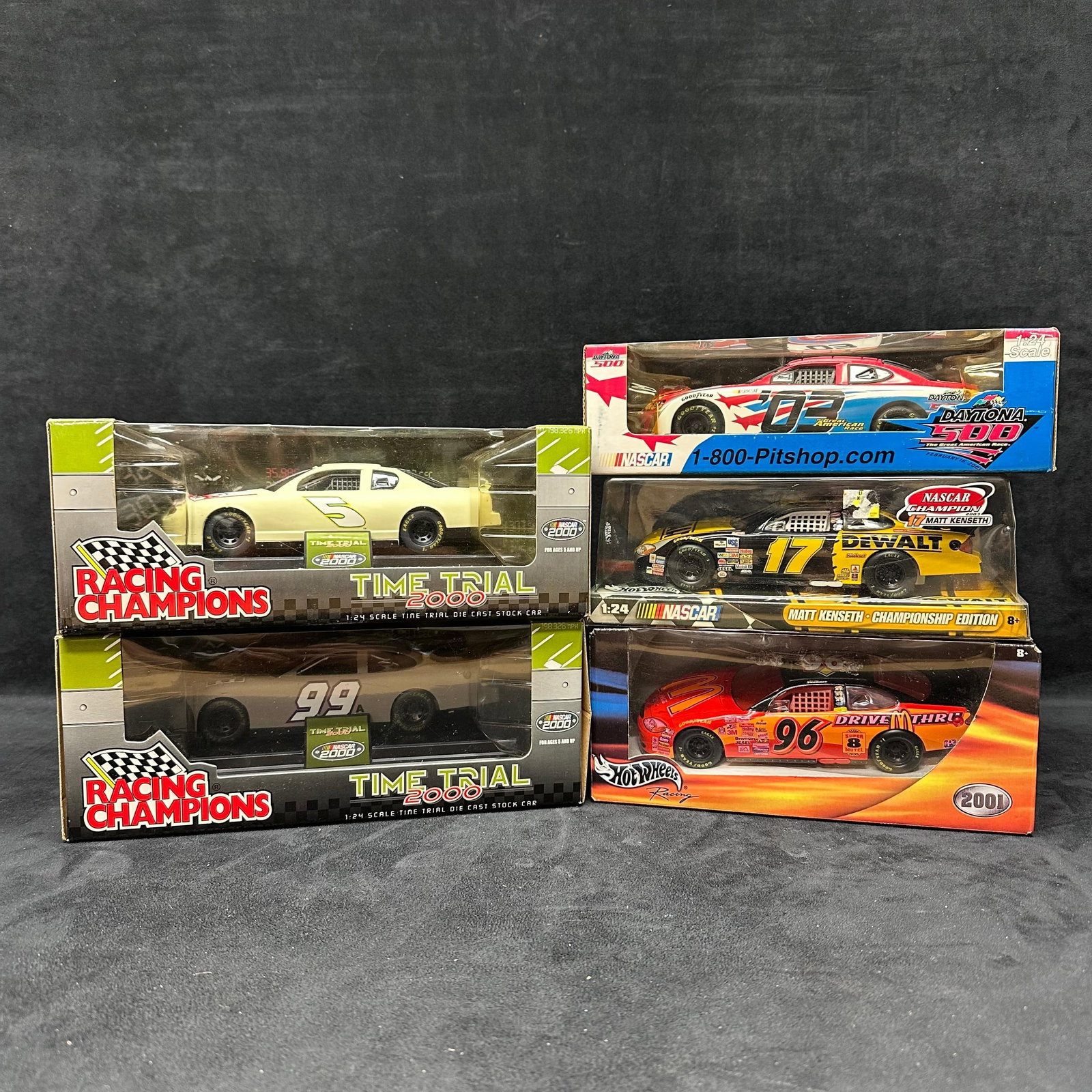 NASCAR Racing Champions Die Cast Stock Car Set of Five 5 Cars 1:24 Scale: Each collectible is sealed new, featuring five Racing Champions, Hot Wheels, and NASCAR brand die-cast cars in 1:24 scale. NASCAR collectibles from the 90's. Outside packaging shows wear with ligh