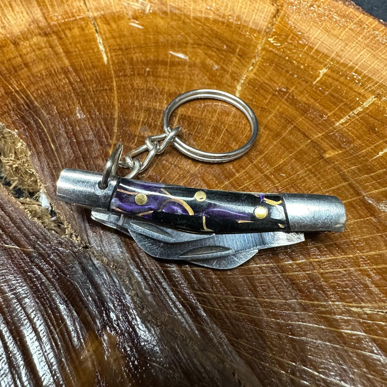 MHS Cutlery Keychain Steel Blade Pocket Knife Purple Handle R48: Small key chain-sized folding-blade pocket knife featuring steel blades and a compact epoxy-resin/wood purple handle secured with brass pins. Includes an attached metal key ring for easy carry. Good