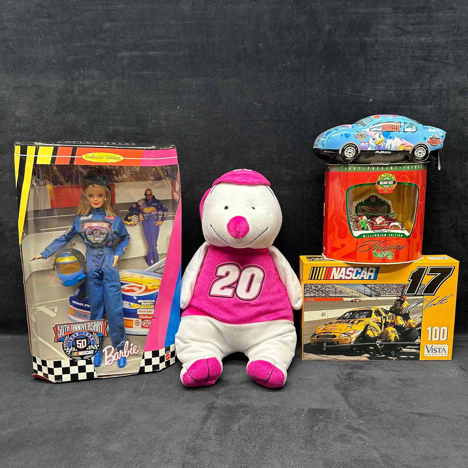 NASCAR Barbie Disney Hot Wheels Toy Collection of Five Collectibles: NASCAR Barbie Disney Hot Wheels Toy Collection of Five Collectibles. This NASCAR collection includes a Barbie Doll, a Disney Race Car Plush, Hot Wheel Holiday themedd car, a puzzle, and a pink and whi