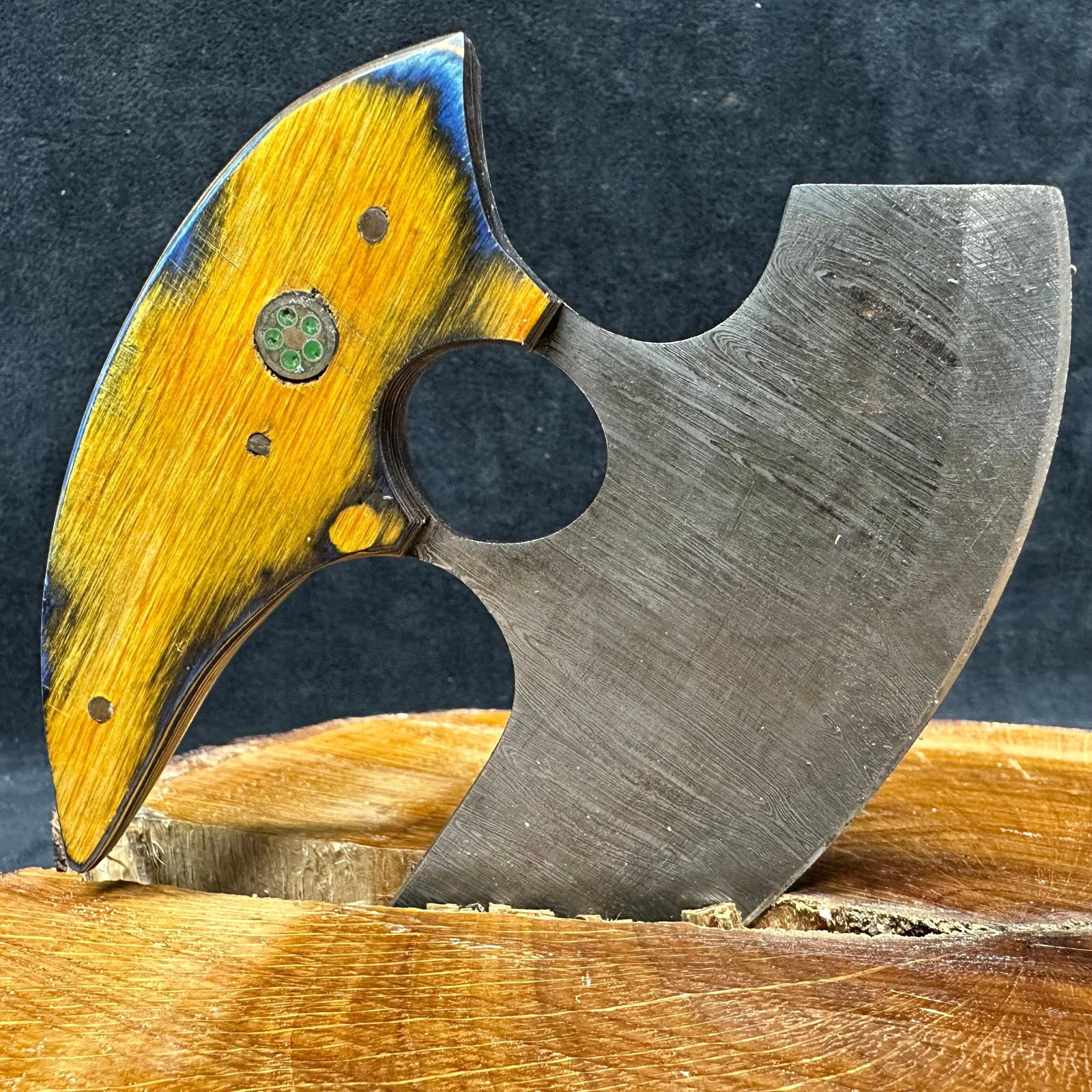 Steel Crescent Axe Ulu Knife MHS Cutlery Curved Blade: Handcrafted crescent-shaped axe knife featuring a patterned steel blade with a broad curved cutting edge. The handle is fitted with a sculpted hardwood epoxy resin style grip, accented with decorative