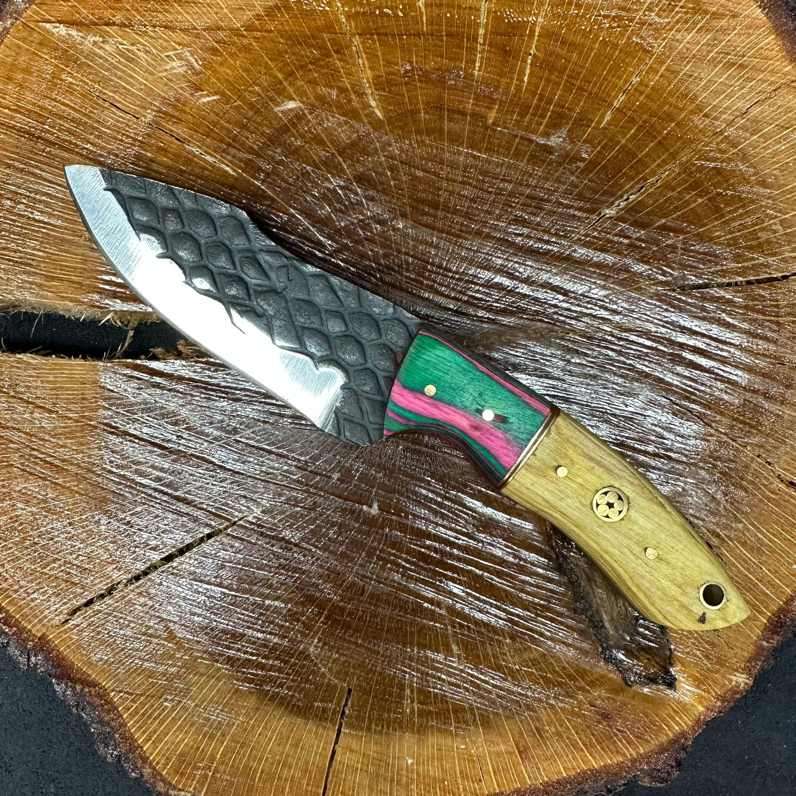 Multi Color Design Handle MHS Cutlery Fixed Blade Knife P88: Fixed blade knife by MHS Cutlery featuring a textured steel straight back blade and decorative spine work. The handle features a contoured, wood/epoxy resin-style grip with metal mosaic pin accents. I