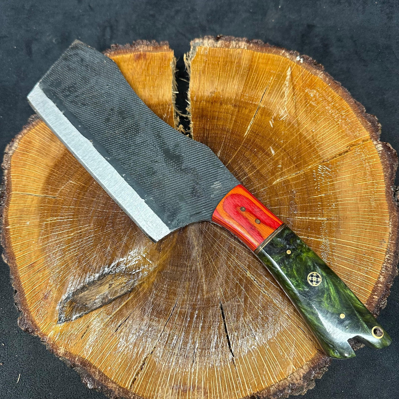 MHS Cutlery Handcrafted Cleaver Knife with Leather Sheath: Handcrafted MHS Cutlery fixed-blade cleaver knife featuring a textured steel blade and a multi-material handle with layered wood and resin accents. Includes fitted brown leather sheath with embossed p