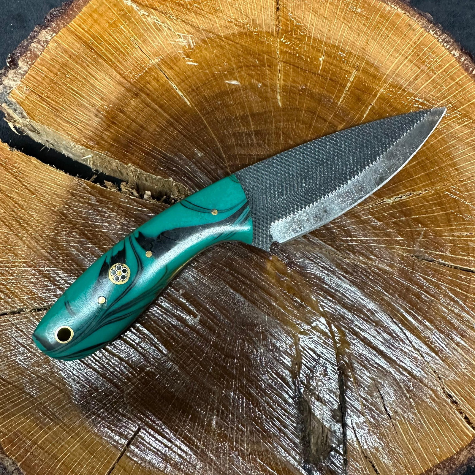 Black and Aqua Blue Green MHS Cutlery Fixed Steel Blade Knife P54: Fixed blade knife by MHS Cutlery featuring a patterned textured steel blade with a curved profile. The handle is constructed with multi-tone stabilized resin/wood material in blue, green, aqua tones,