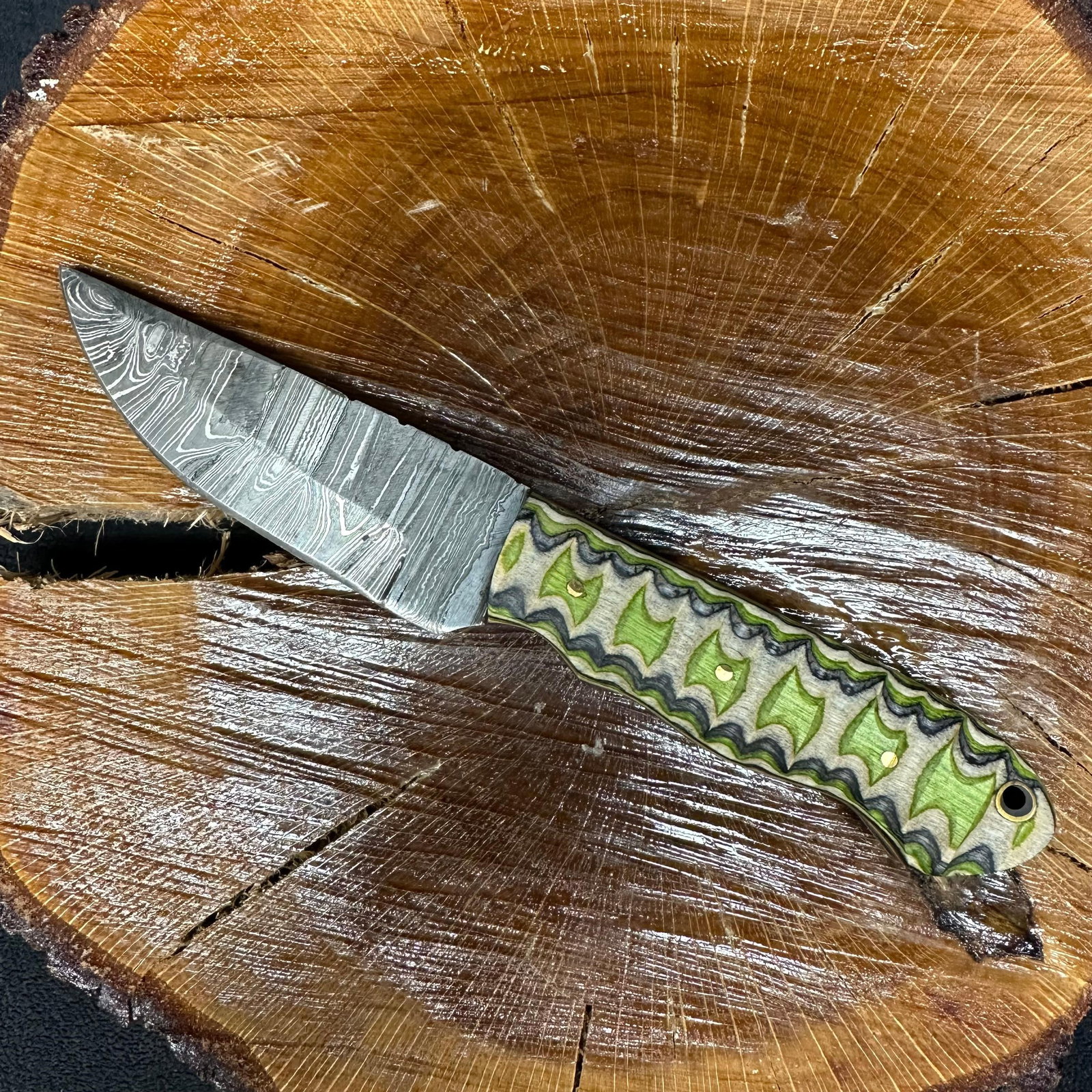 MHS Cutlery Fixed Steel Straight Blade Knife P73 Brown Green Handle: Fixed blade knife by MHS Cutlery featuring a patterned steel blade with a straight profile. The textured, carved handle is constructed with multi-tone stabilized epoxy resin/wood material in brown, gr
