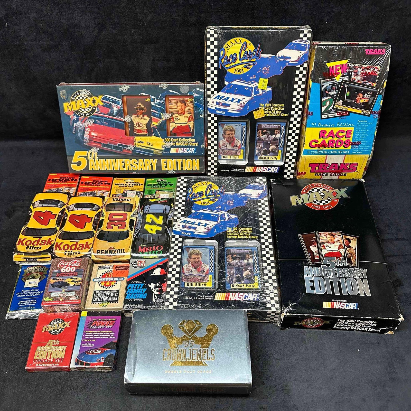 NASCAR Trading Card Set Maxx Traks Box Cards: NASCAR Trading Card Set Maxx Traks Box Cards. This includes several NASCAR box sets some are opened but most are like new sealed. Several brands such as Coca Cola, Traks, Maxx, and others. These items