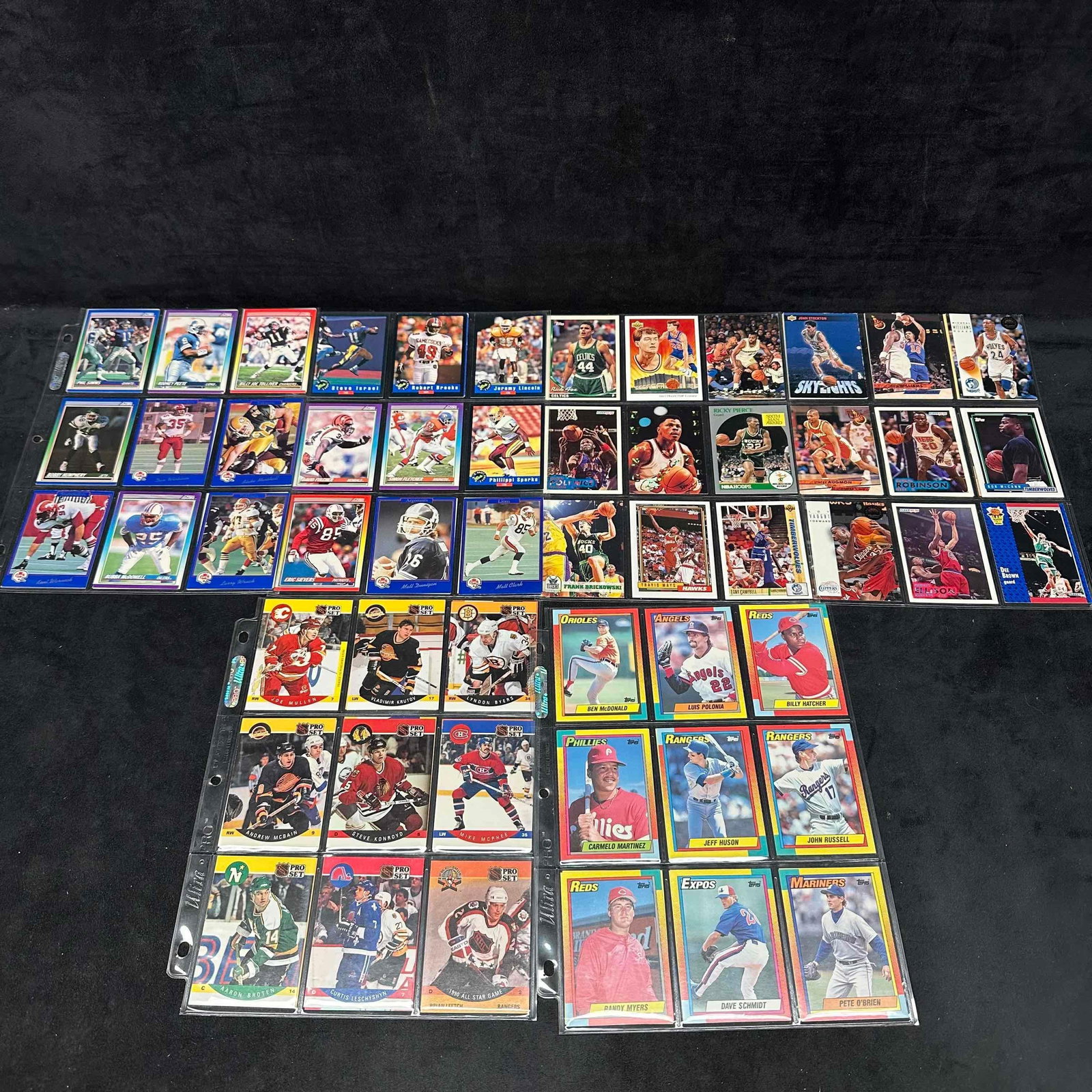 Collection of Sport Cards NFL Football MLB Baseball NHL Hockey NBA Basketball Card Binder: Ninety (90) plus cards included in this collection from various sports, all older sport cards. Includes Ultra-Pro card protector sleeves and green plastic binder. Dennis Rodman, Phil Simms, Cris Carte