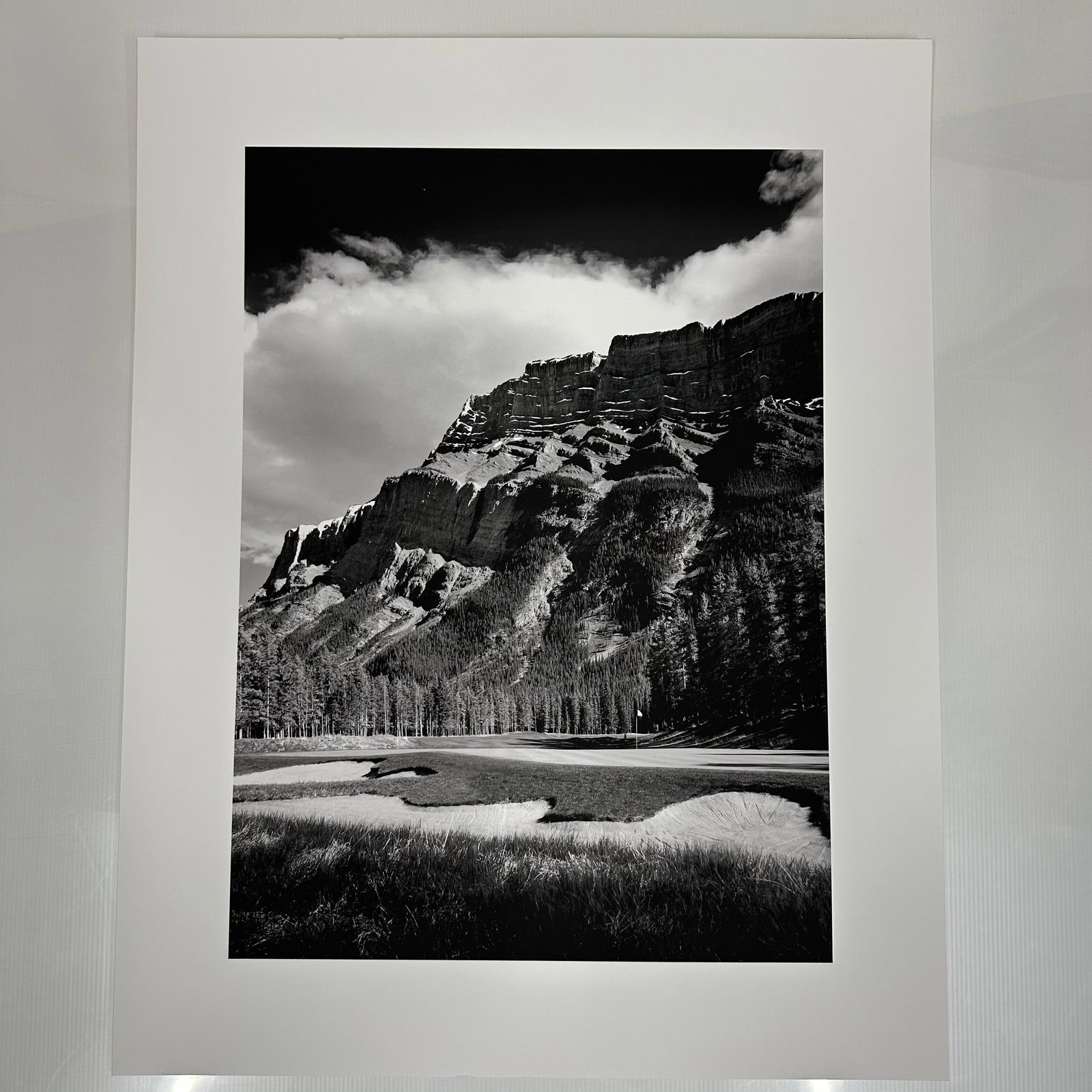 Black and White Landscape Photograph Print Mountain and Golf Course Scene Large Format A: Large format black and white photography print showing a dramatic mountain range rising above a golf course. The image features strong contrast, detailed texture, and balanced composition. Printed on