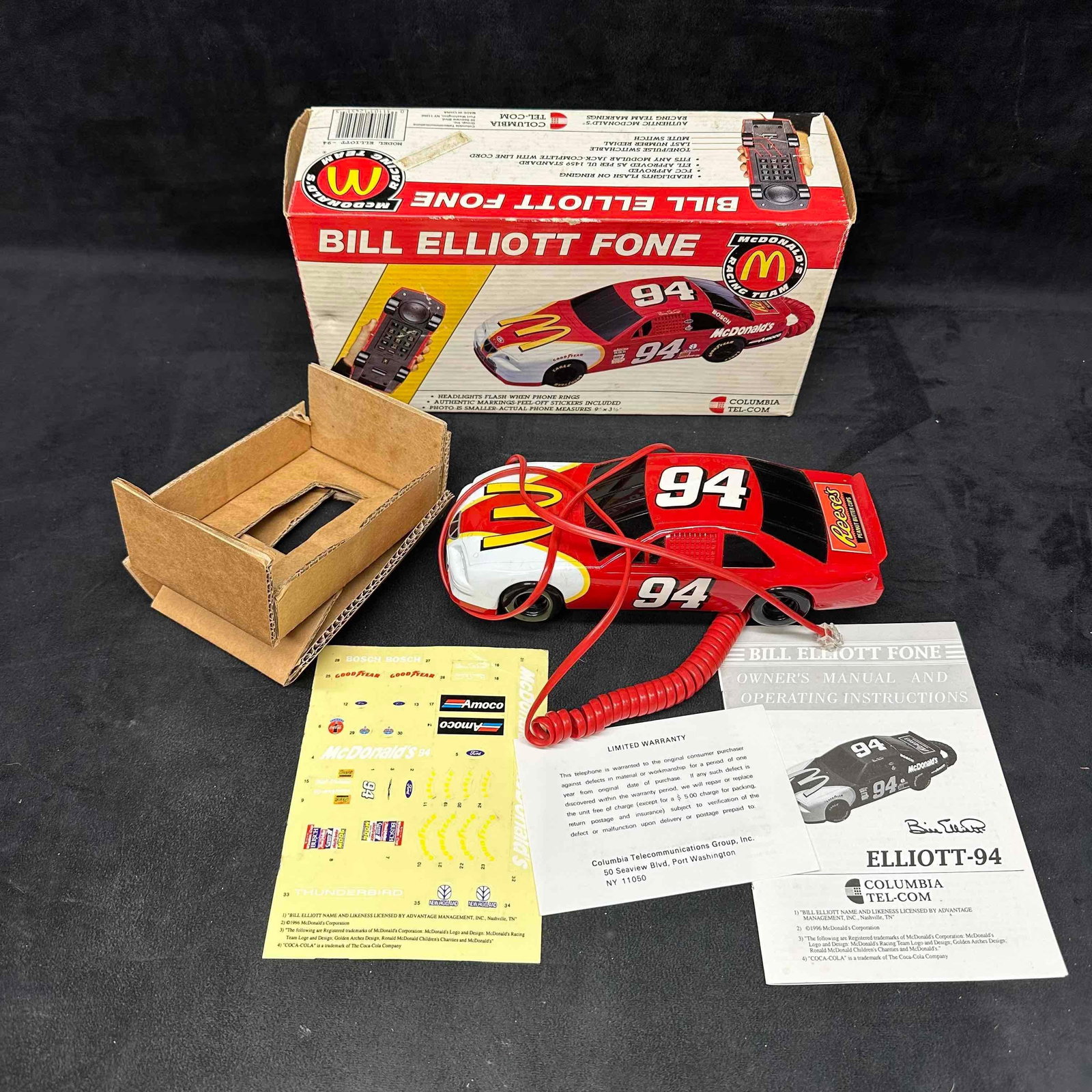 1990's Bill Elliott McDonald’s #94 Race Car Telephone: Vintage Columbia Tel-Com Bill Elliott #94 McDonald’s Racing Team corded telephone. Shaped like a stock car with flashing headlights when the phone rings. Includes original box, instructions, warrant