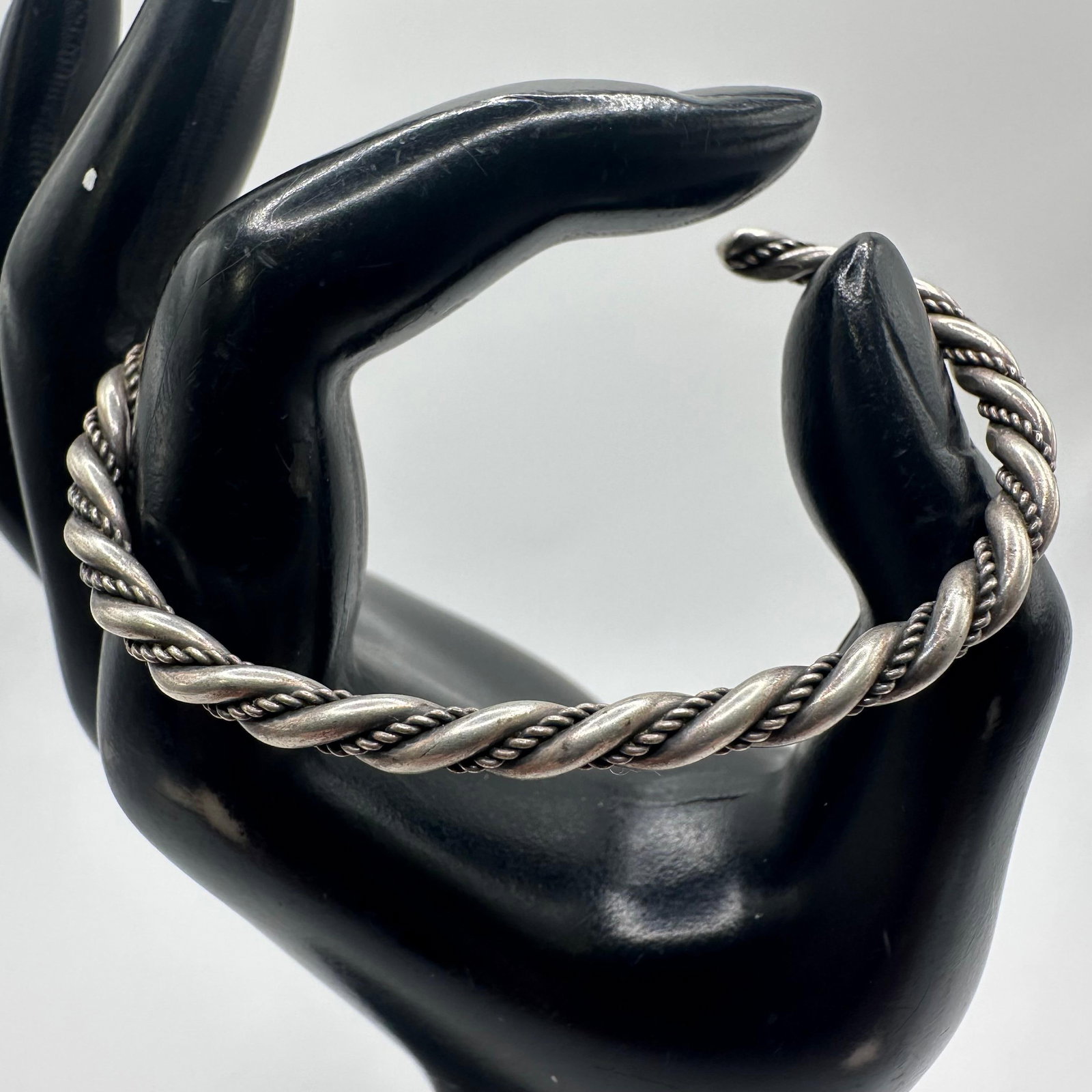 Silver Twisted Rope Cuff Bracelet X91: This item is in good pre-owned, previously used/displayed condition with noticeable light wear and surface scratches. Please reference all photos for full details. This piece of jewelry has been teste