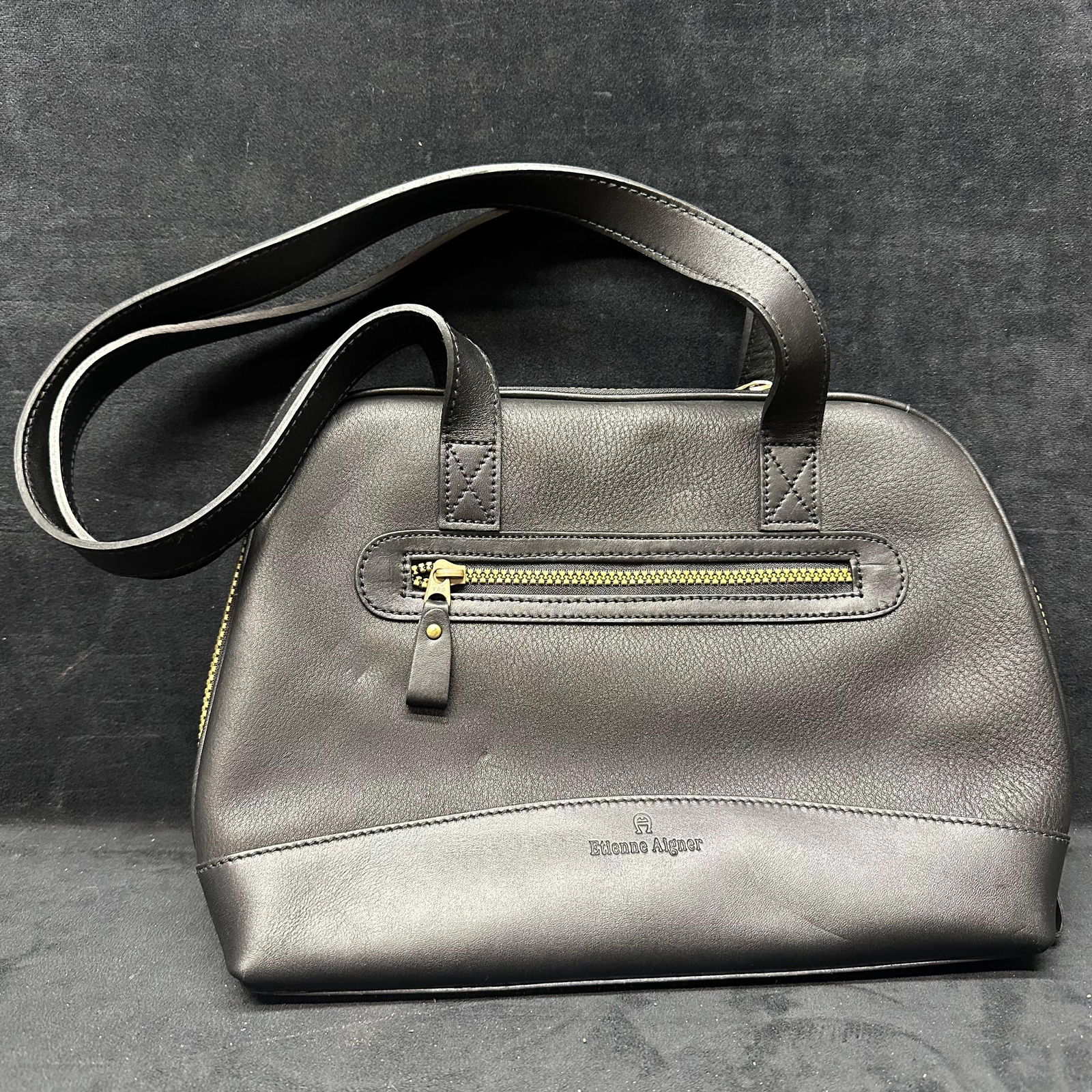 Etienne Aigner Black Handbag Purse: Shows visible wear and scuffing consistent with use, particularly to the exterior leather and handles. This item is in good pre-owned, previously displayed condition with light wear and surface