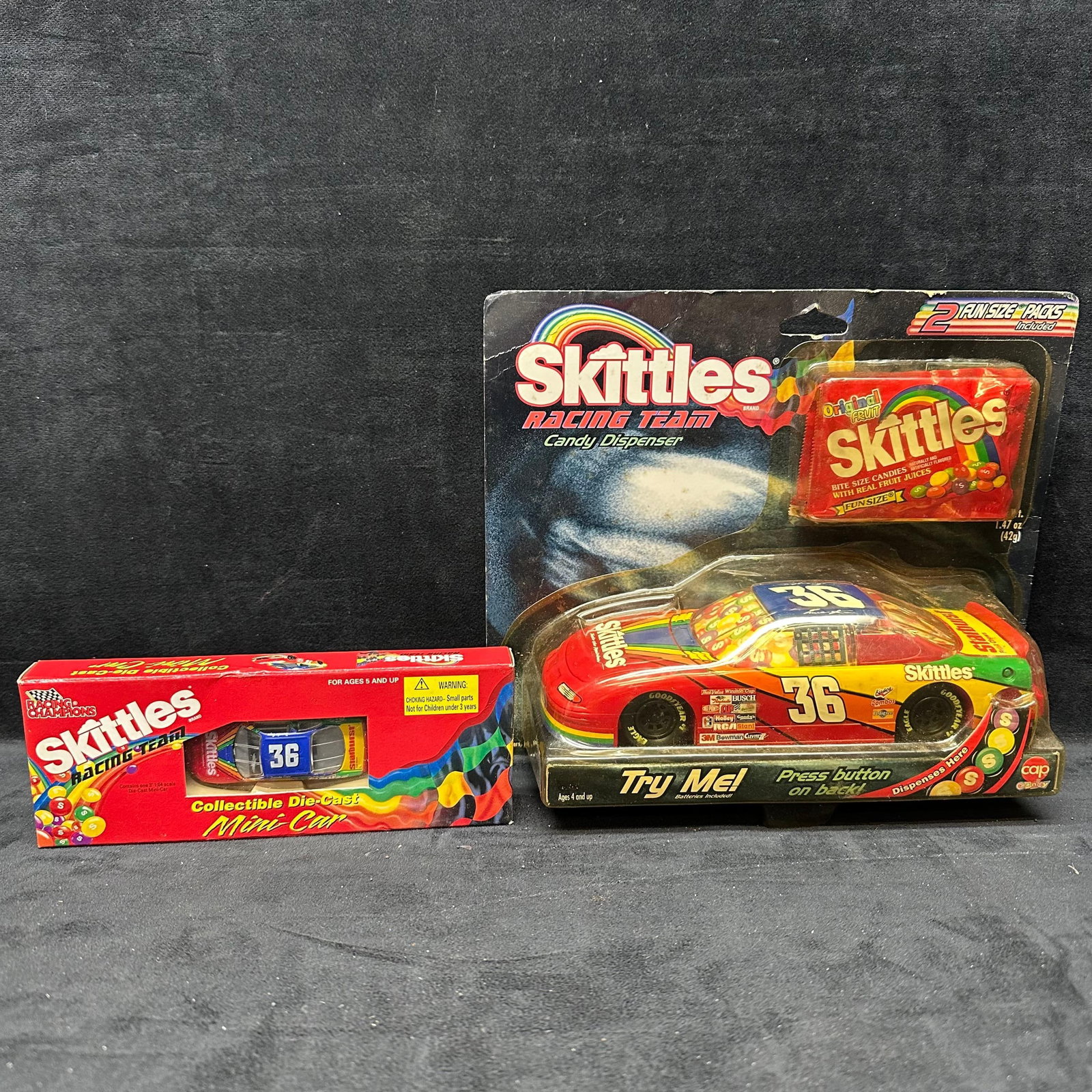 Skittles Racing Team #36 Candy Dispenser Car and Die-Cast Mini Car Set: Lot includes Skittles Racing Team #36 themed items, featuring a candy dispenser stock car in original blister packaging (includes fun-size Skittles packs) and a Racing Champions collectible die-cast m