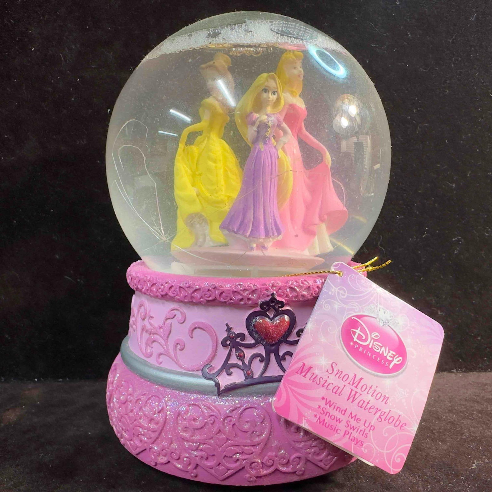 Kcare Disney Princess Belle Rapunzel Aurora Pink Musical Snow Globe: Kcare Disney Princess Belle Rapunzel Aurora Pink Musical Snow Globe. This Kcare Disney musical snow globe features three Disney Princesses Aurora, Belle, and Rapunzel. The music box plays the sweet me