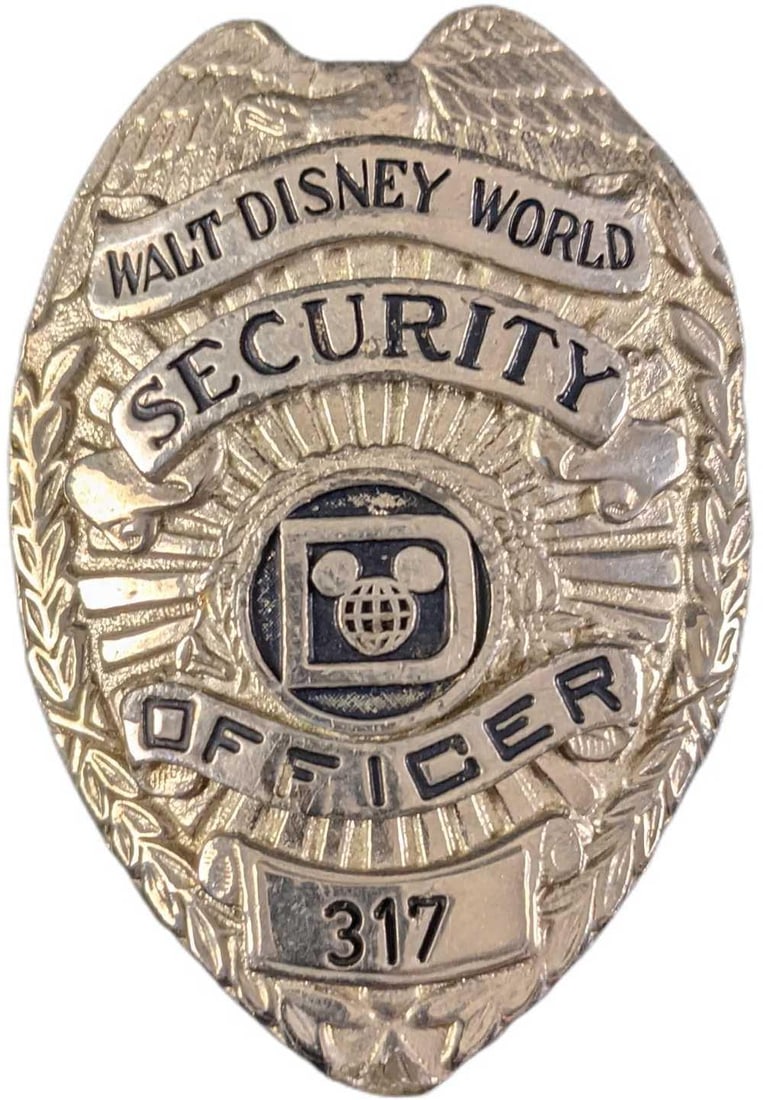 1970s/1980s Disney World Security Metal Badge: 1970s/1980s Disney World Security Metal Badge. Is approx 2 1/4" x 3/4" x 3" and it weighs under one pound at 0.13lb. The metal badge is in a good, vintage condition with some wear, paint loss and mini