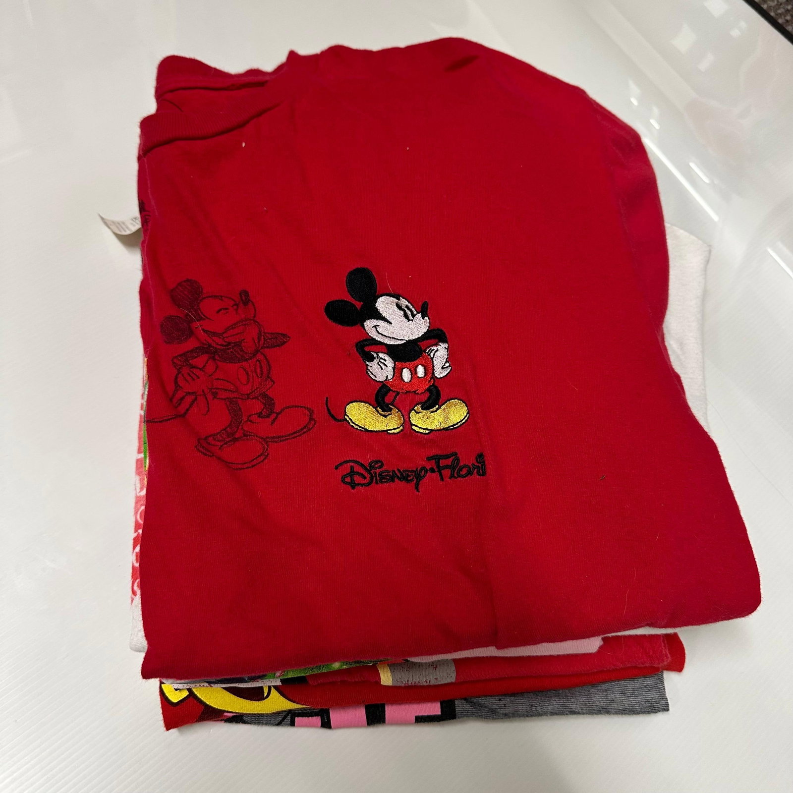 Variety Lot of Mickey Mouse Disney Tees Woman and Men T-Shirt Lot Eight: A variety of Disney family tees ranging from youth to adult men and women sizes. Pre-owned; light wear and fading consistent with normal use. These items are in pre-owned, previously displayed conditi