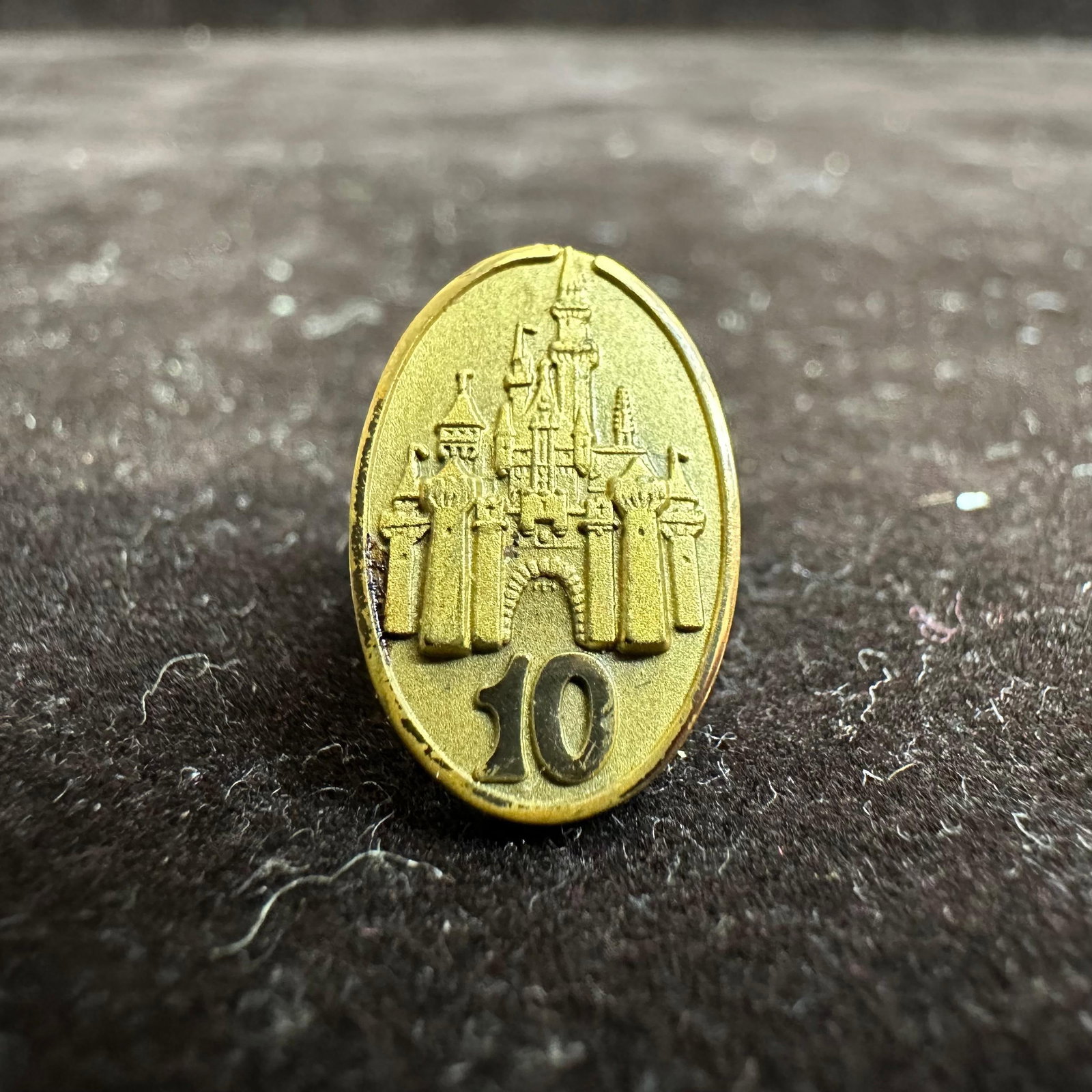 Walt Disney World 10 Year Cinderella Castle Cast Member Service Award Pin: This pin is presented to the Cast Member by Disney when they reach 10 years of service (employment) on or around the anniversary of their date of hire and features Cinderella Castle. The pin is worn o